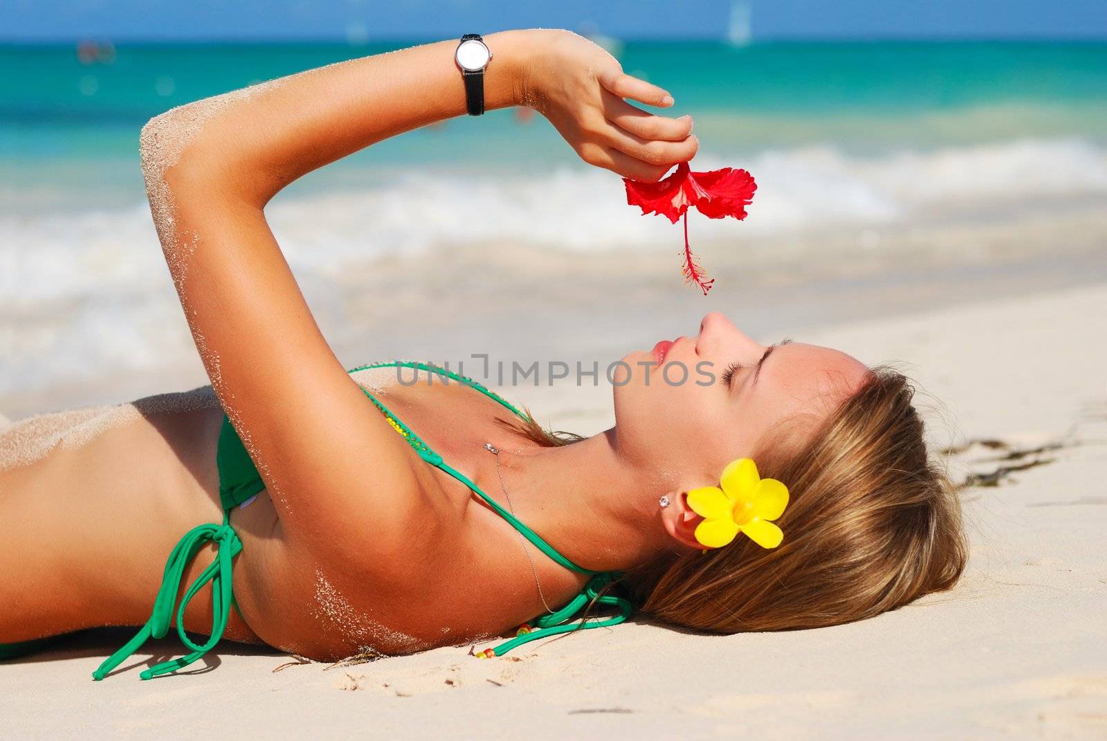 Girl with flower on caribbean beach