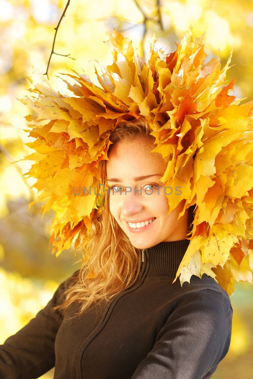 Girl with yellow autumn leaves