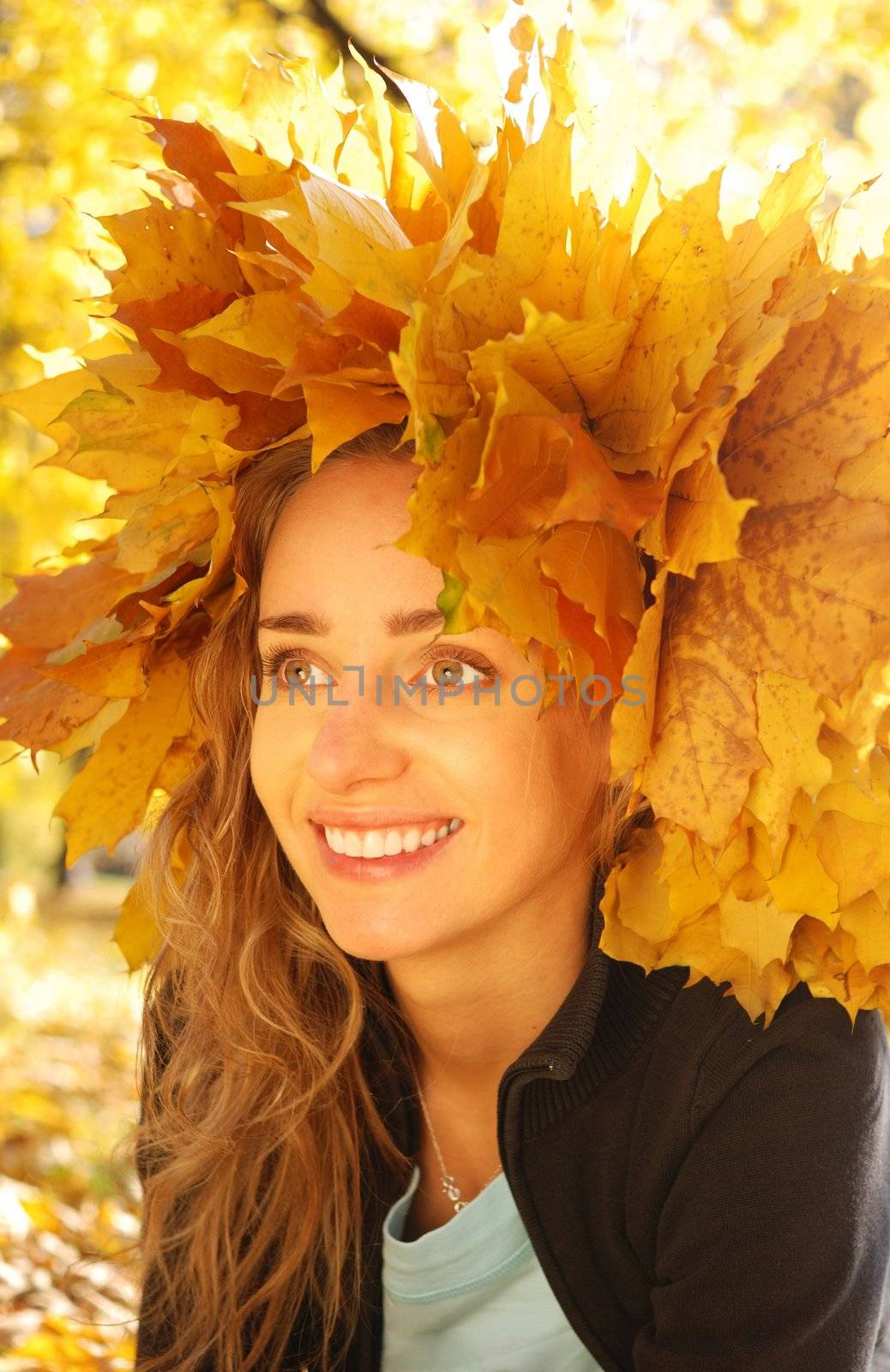 Girl with yellow autumn leaves