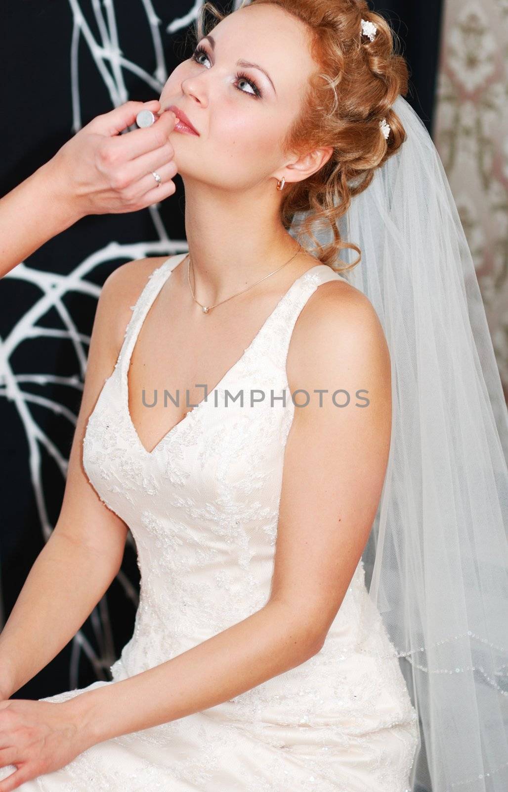 Bride having her makeup applied