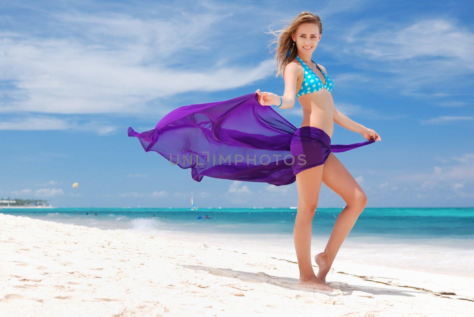 Woman with sarong on caribbean beach
