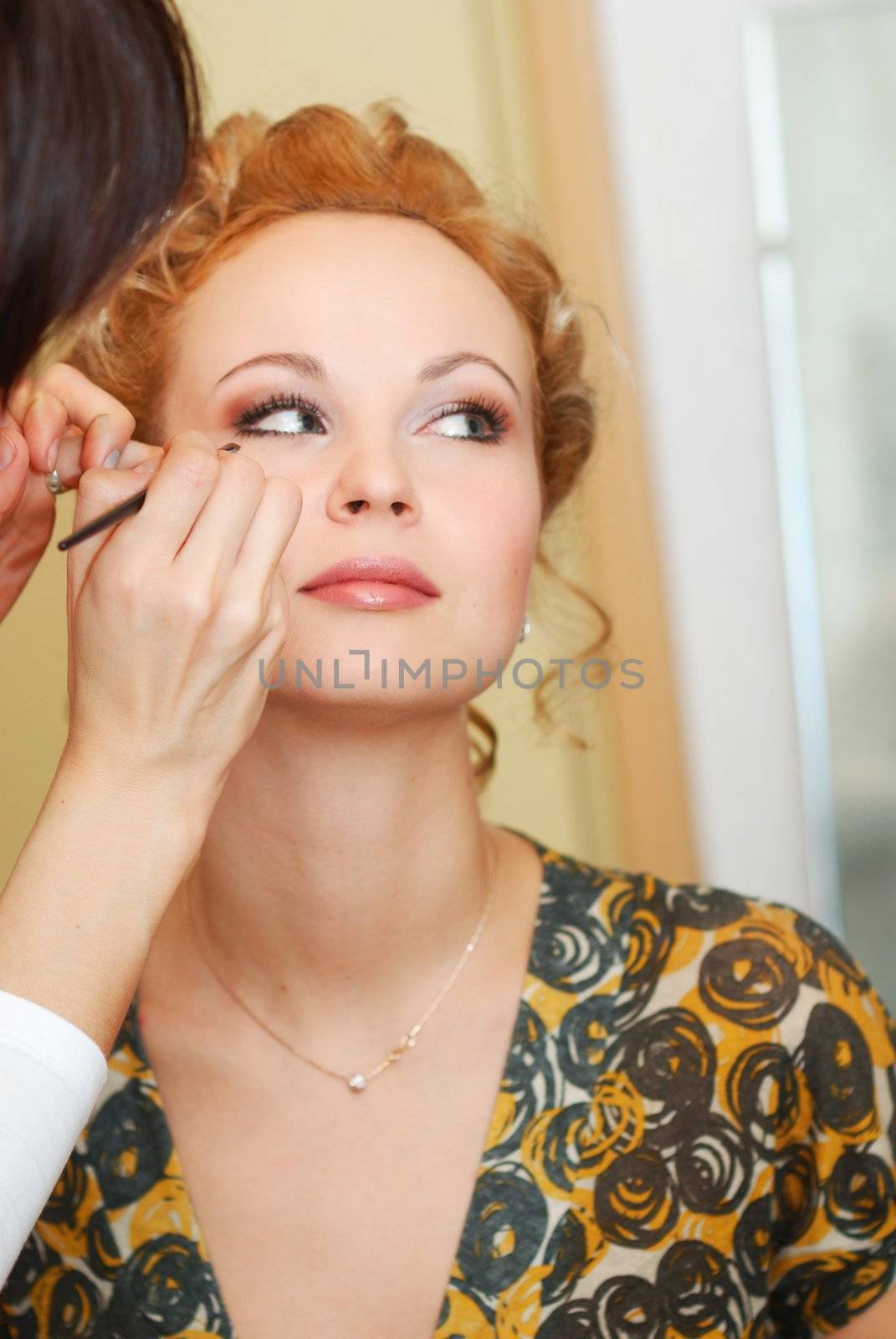 Woman having her makeup applied