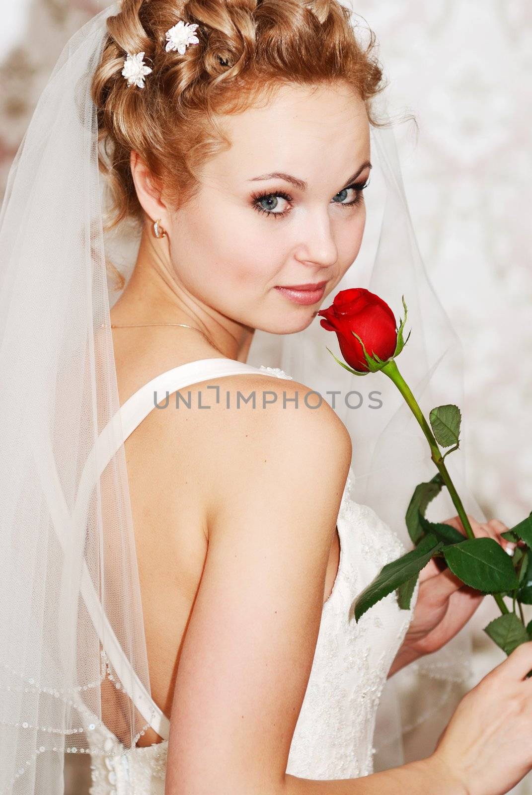 Beautiful bride holding red rose