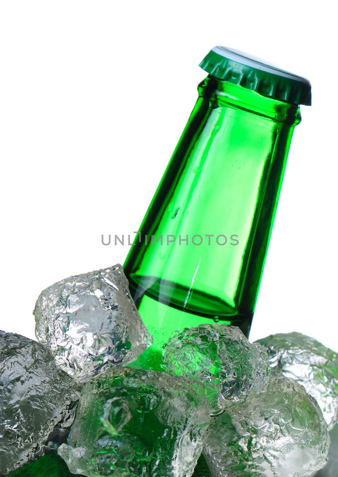 Green beer bottle in ice isolated on white