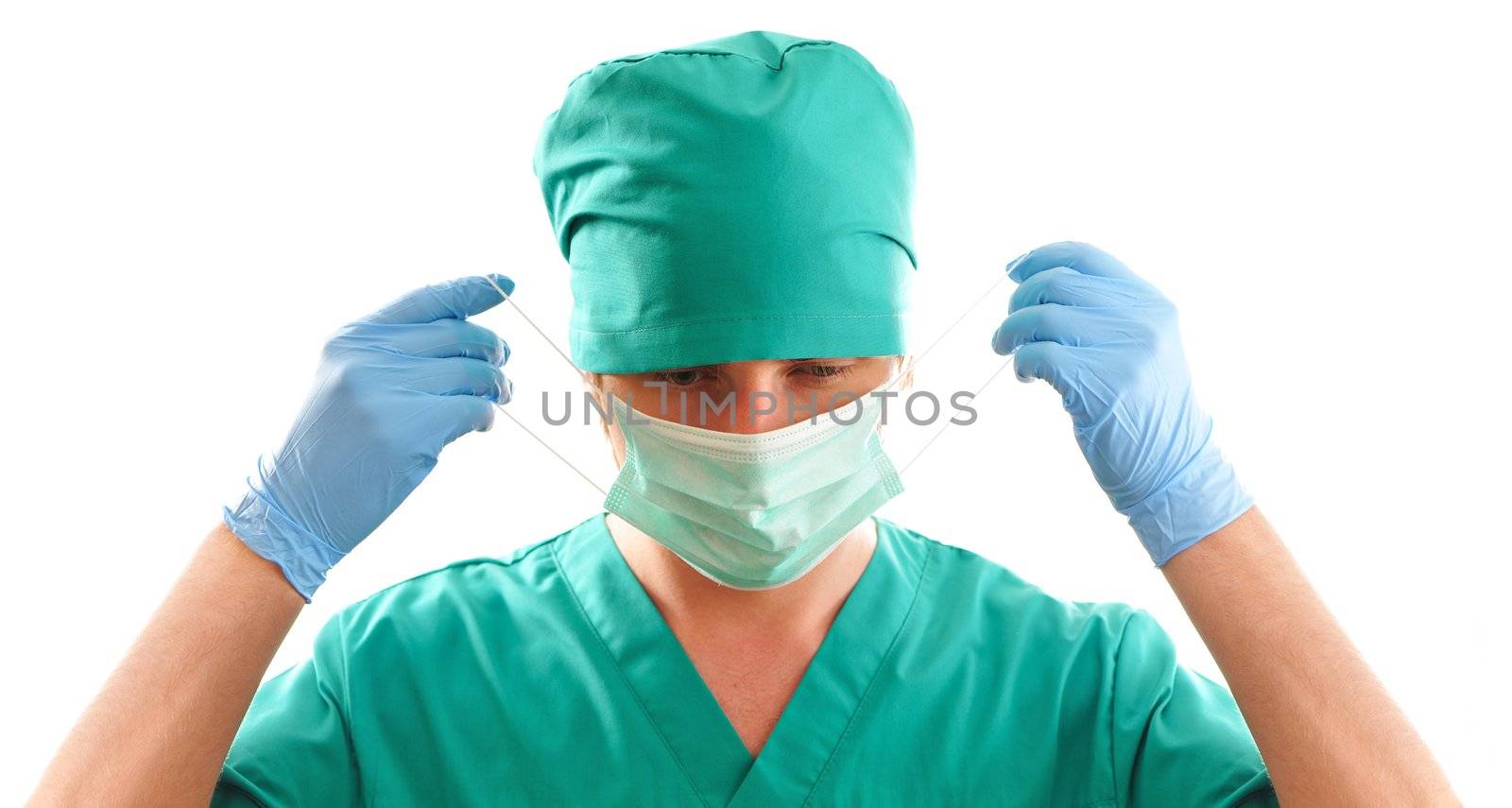 Doctor pulling on surgical mask
