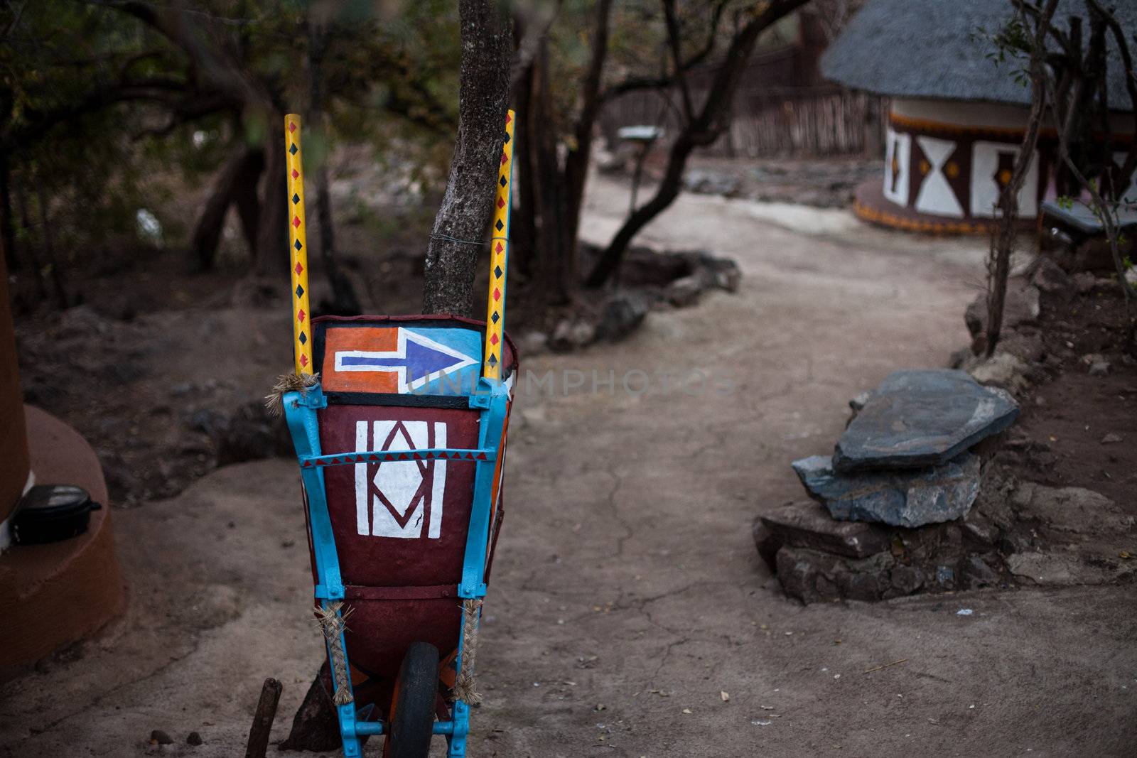 Right-pointing arrow painted on a traditional African wheelbarrow