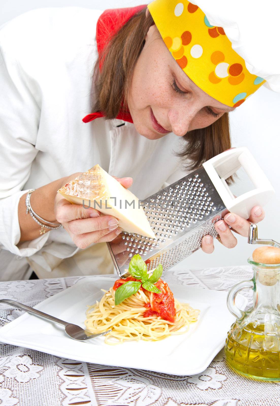  smiling chef garnish an Italian pasta dish 