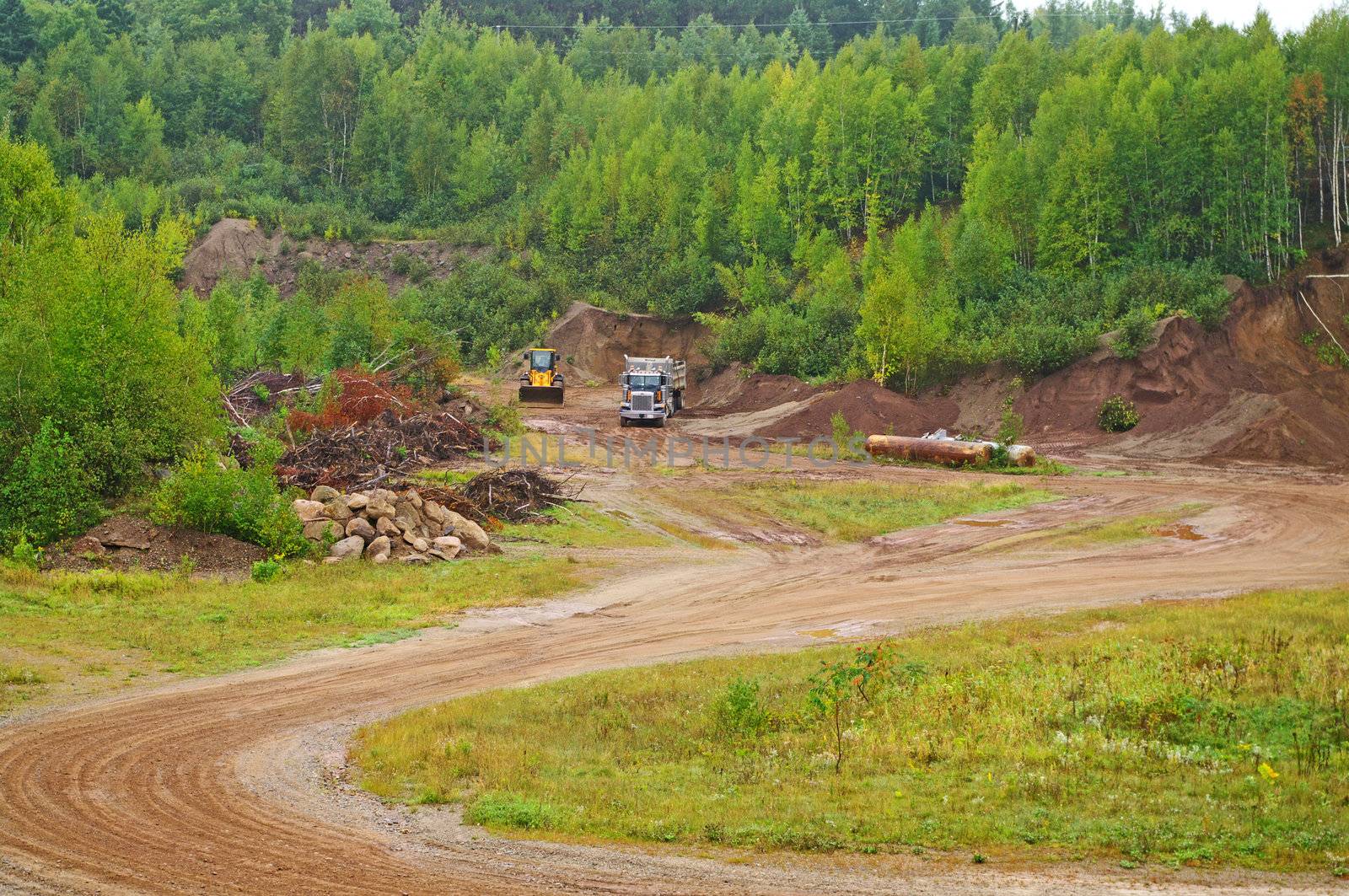 A dump truck being loaded with gravel