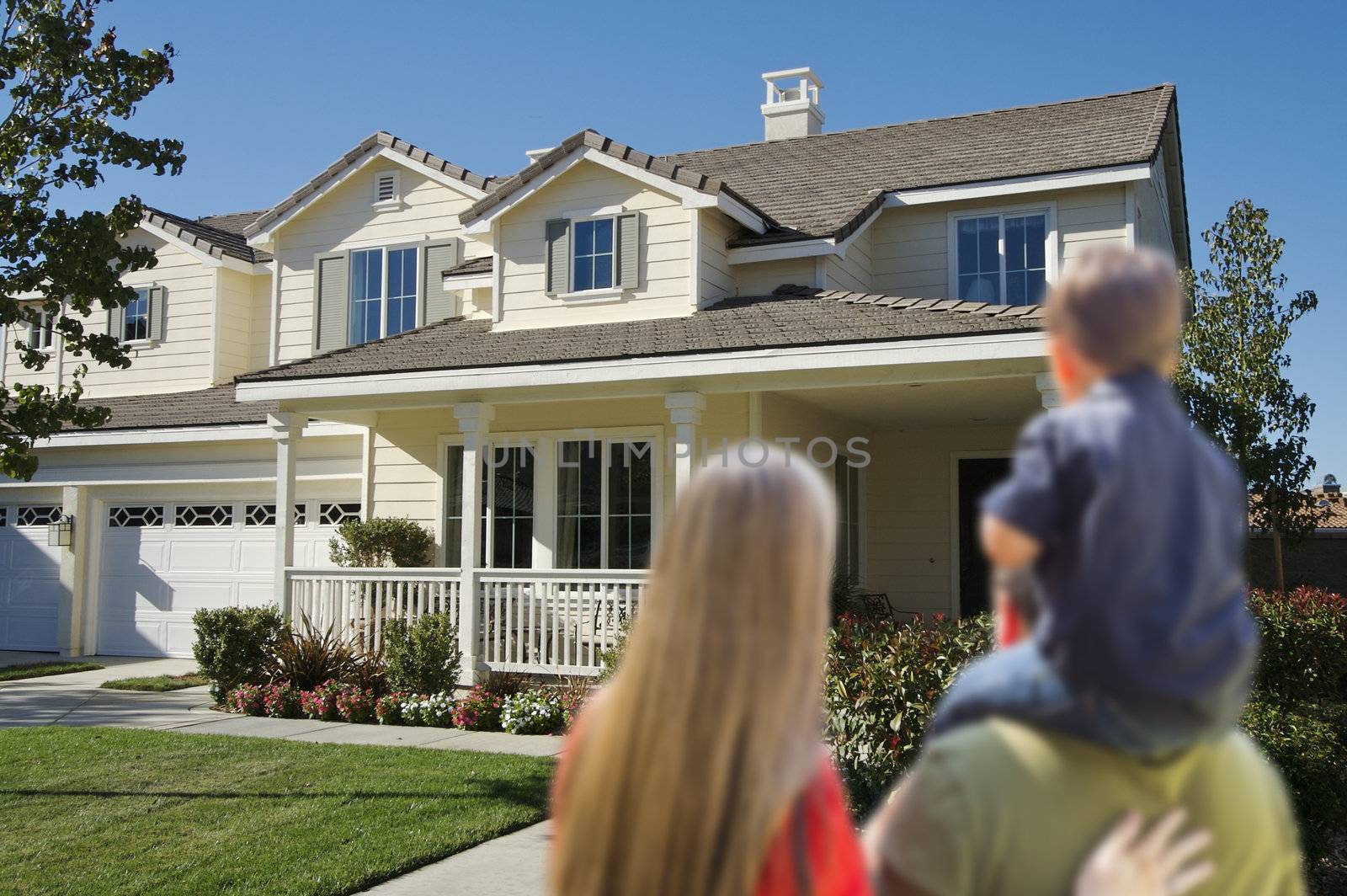 Young Family Looking at a Beautiful New Home.