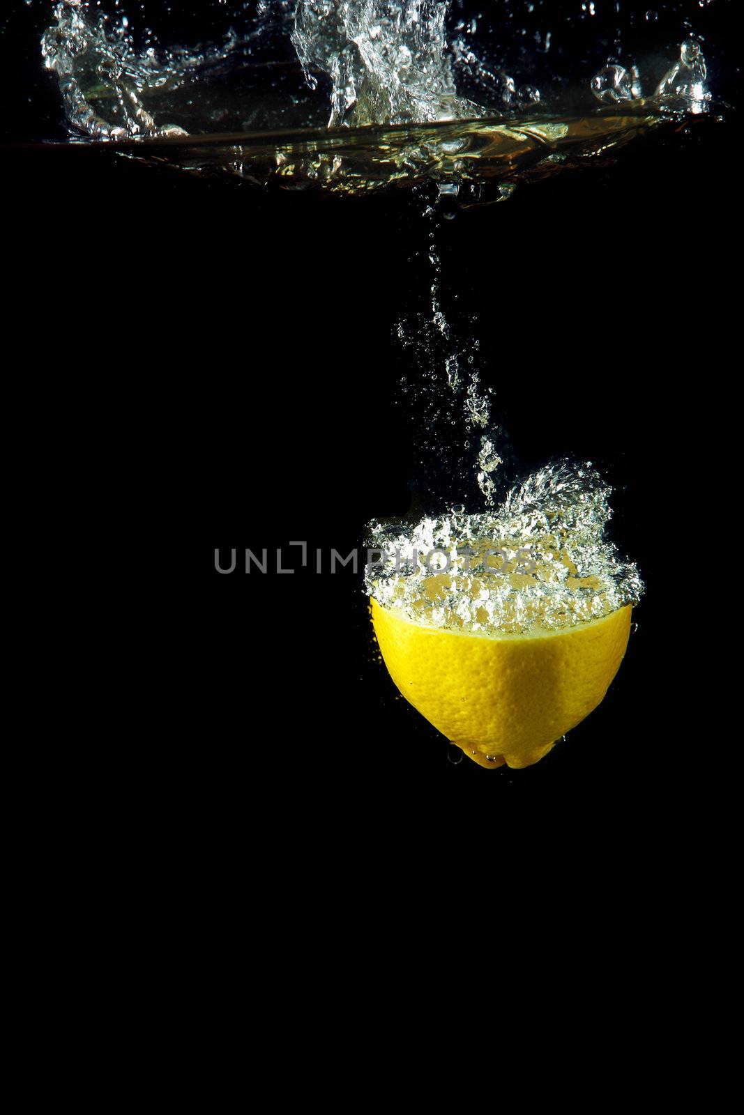 fresh lemon under water by sergey_nivens