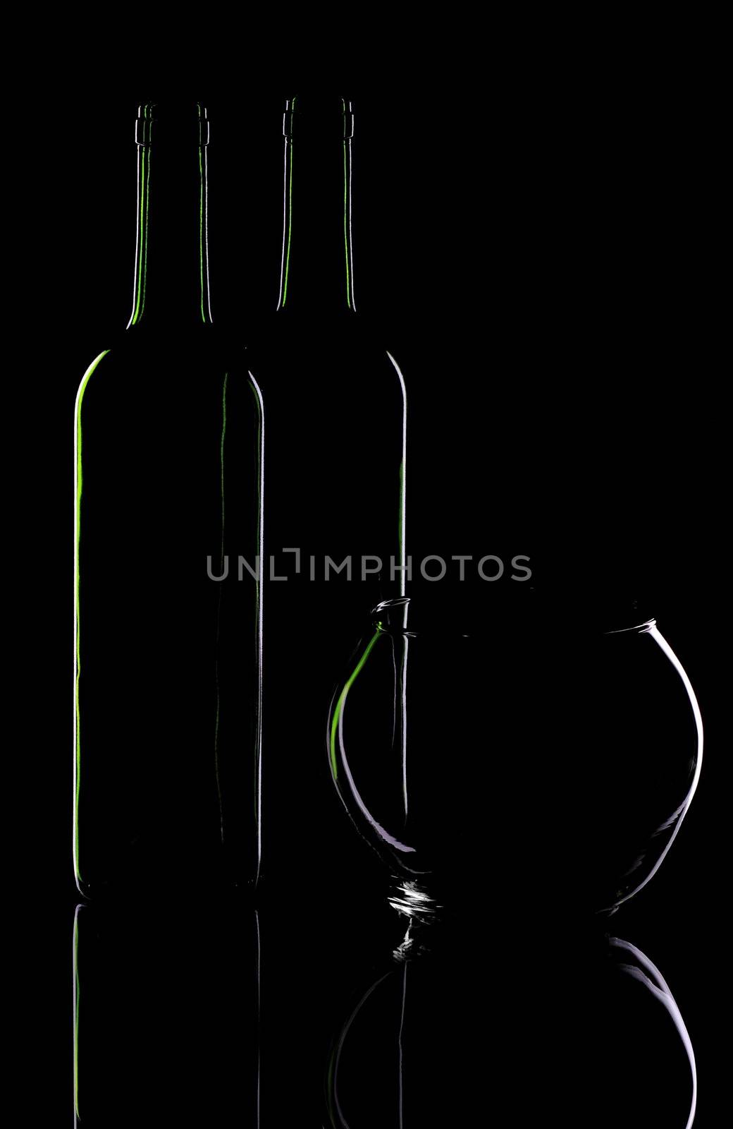 Wine bottle and glass vase on a black background
