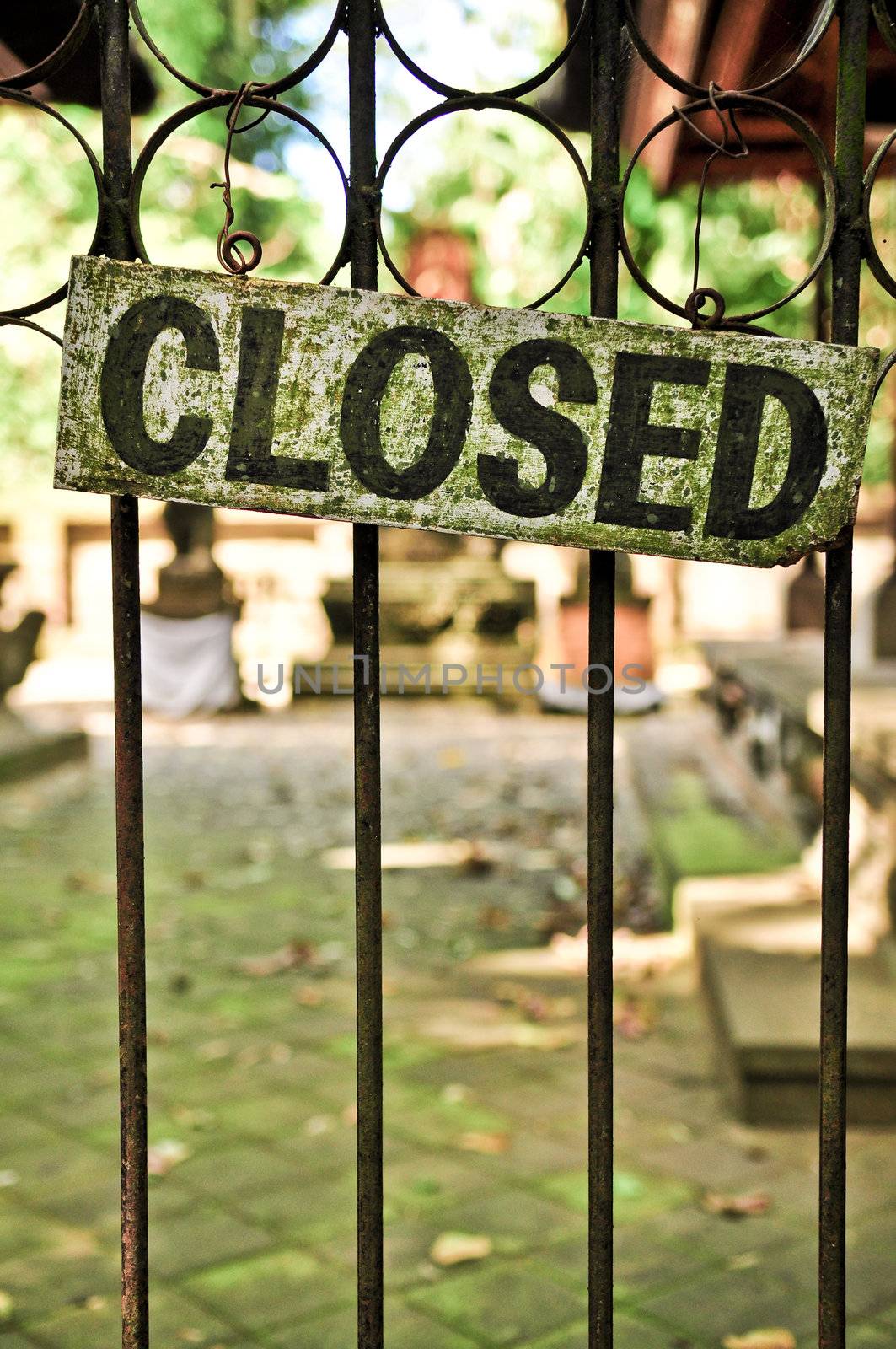 Closed sign on the metal door bars, detail view