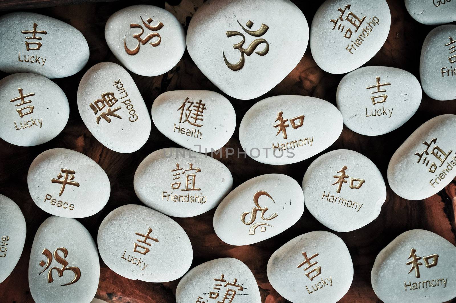 Fortune stones with symbols and writings settled on a wooden table