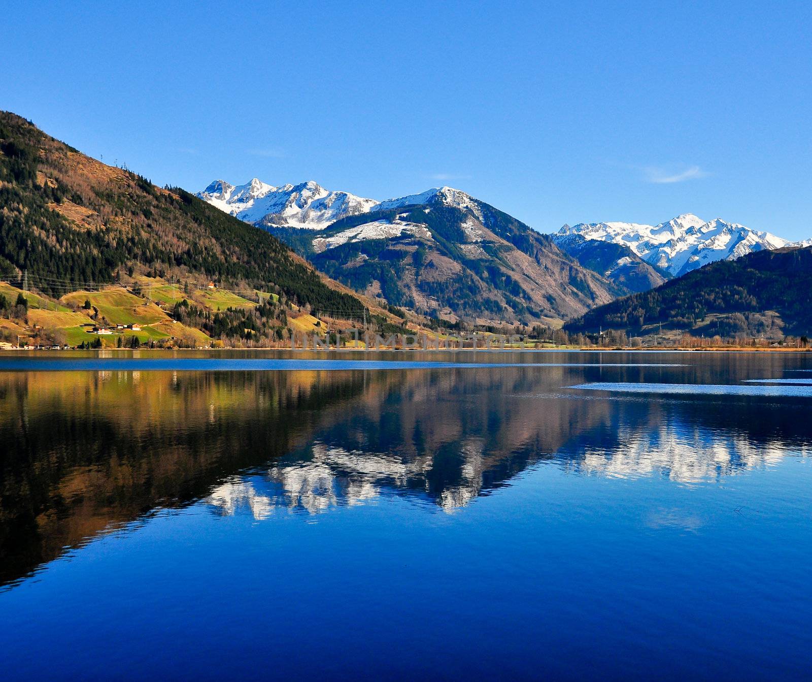 Blue mountain lake landscape view with mountain reflection, Zell am See, Austria