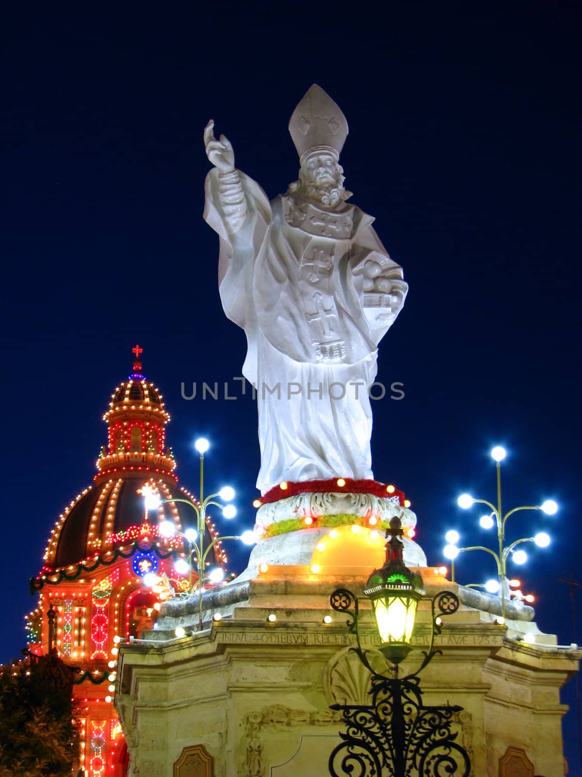 A stone sculpture of Saint Nicholas in the church square of Siggiewi in Malta.