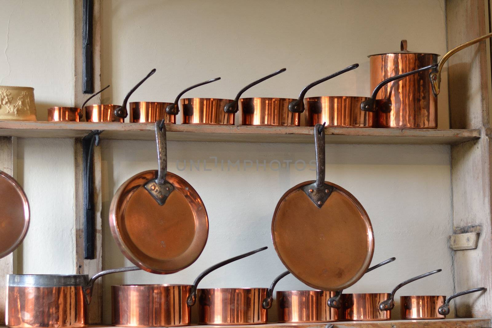 Row of copper pots by pauws99