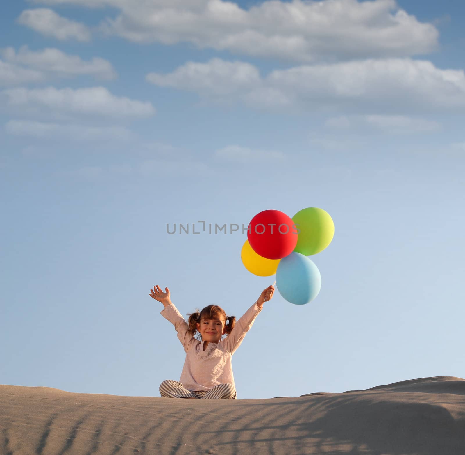 happy little girl with colorful balloons