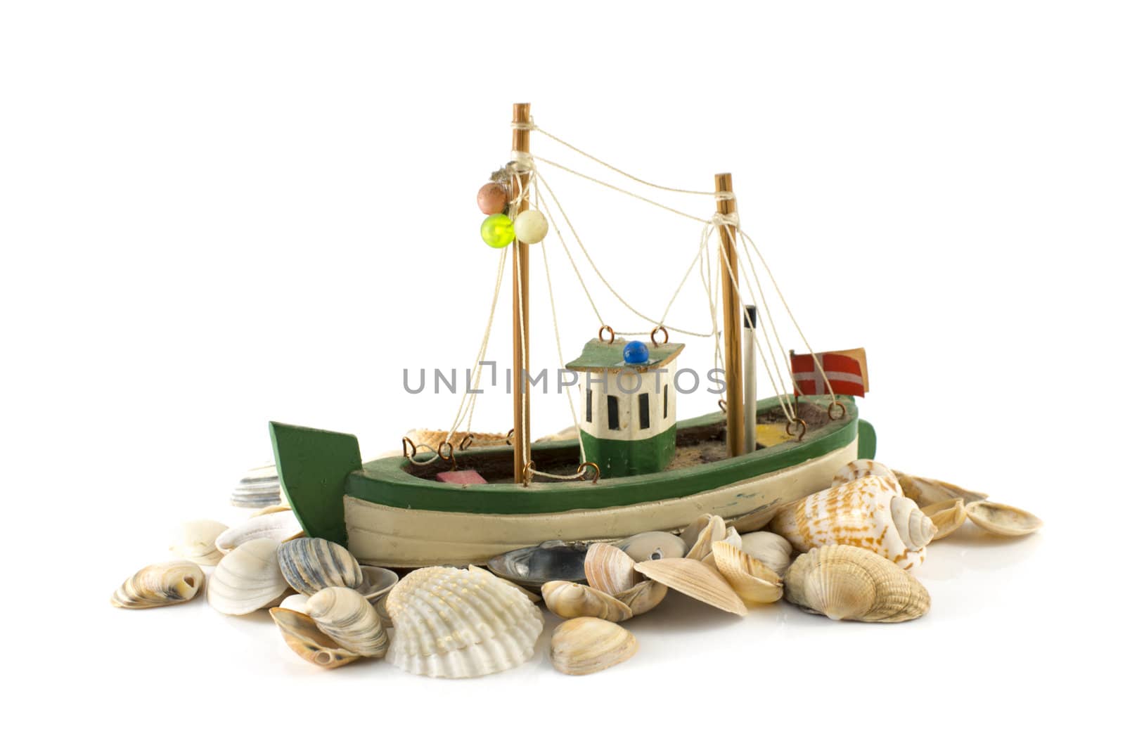 old danish model fish boatand beach shell isolated on white