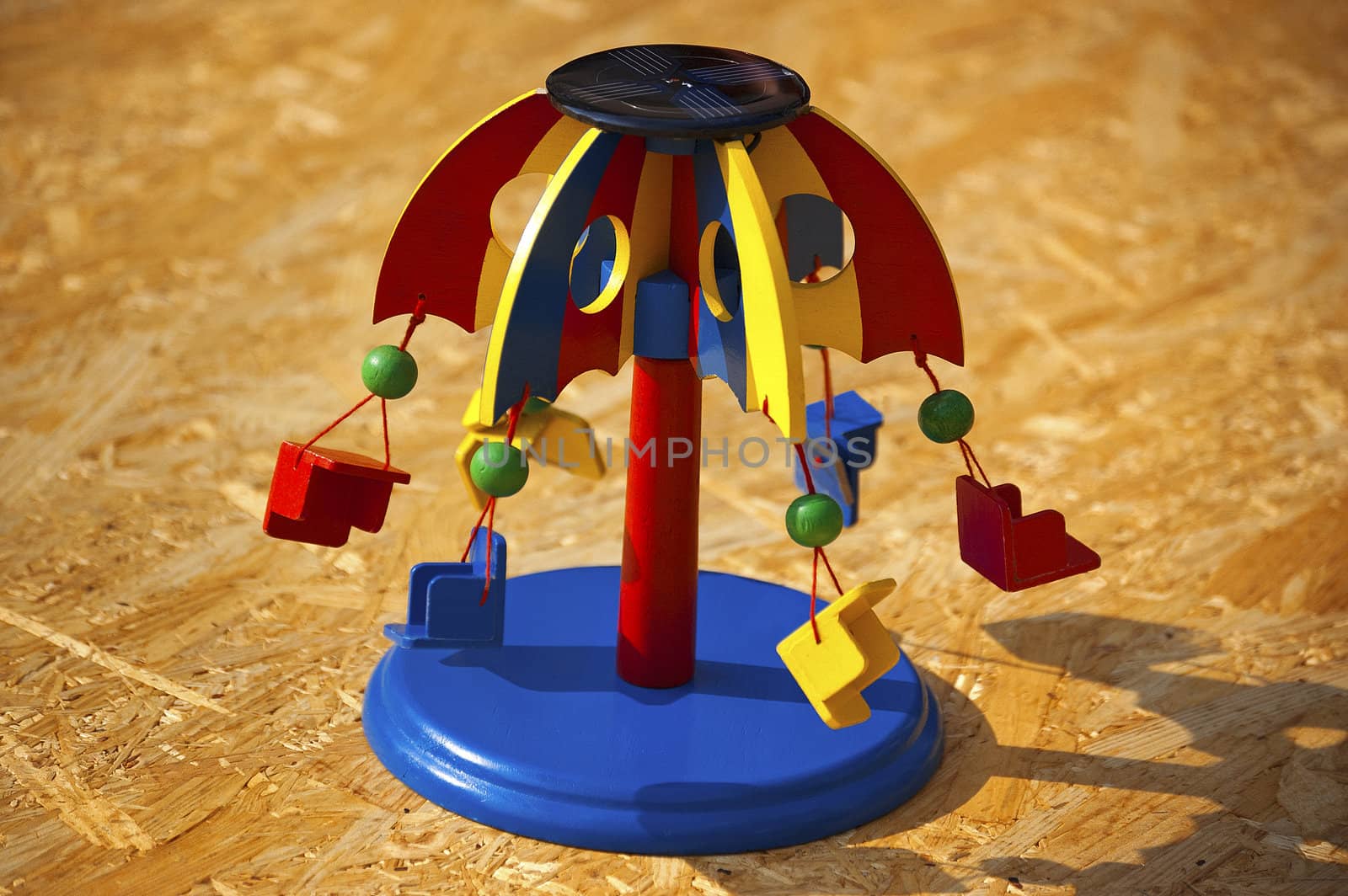 Prescholl carousel toy on wooden background
