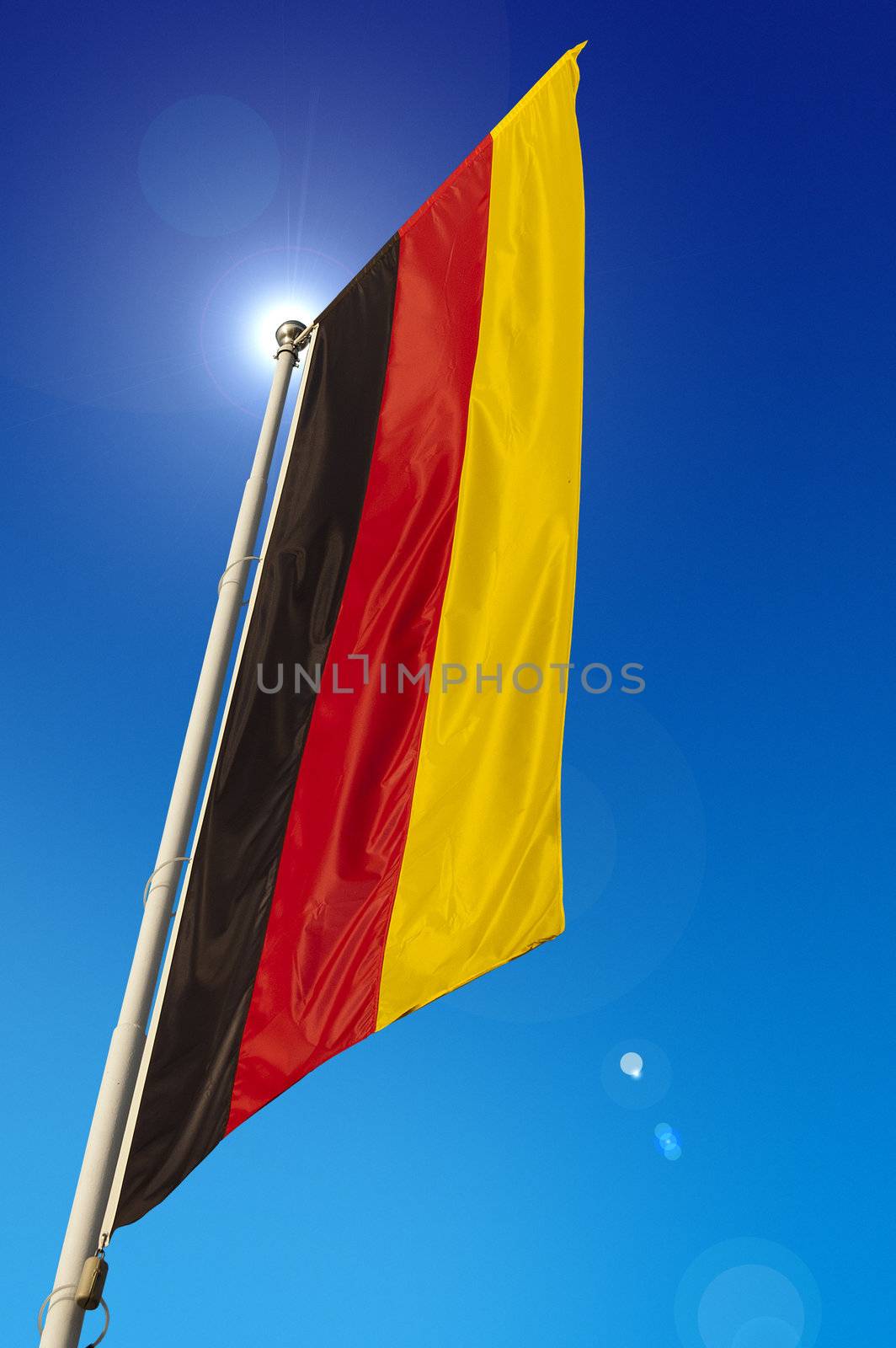 Vertical Germany Flag - waving in the blue sky
