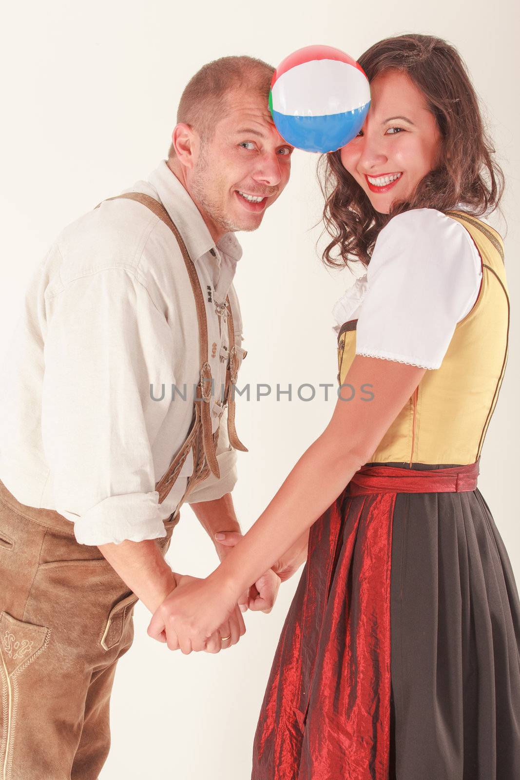 In love, laughing couple in Bavarian costume by STphotography