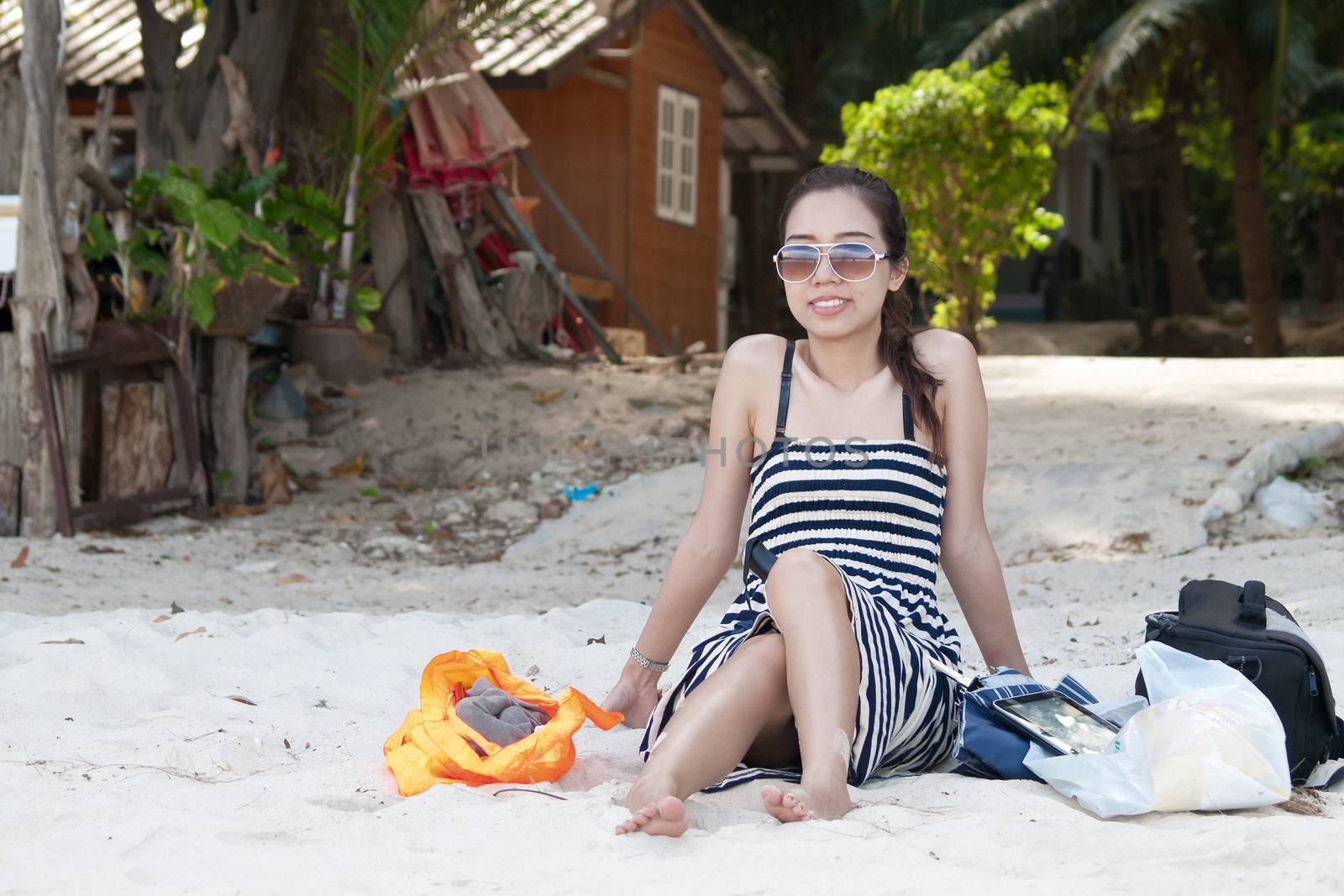 Asian Women sit on the Beach by jakgree