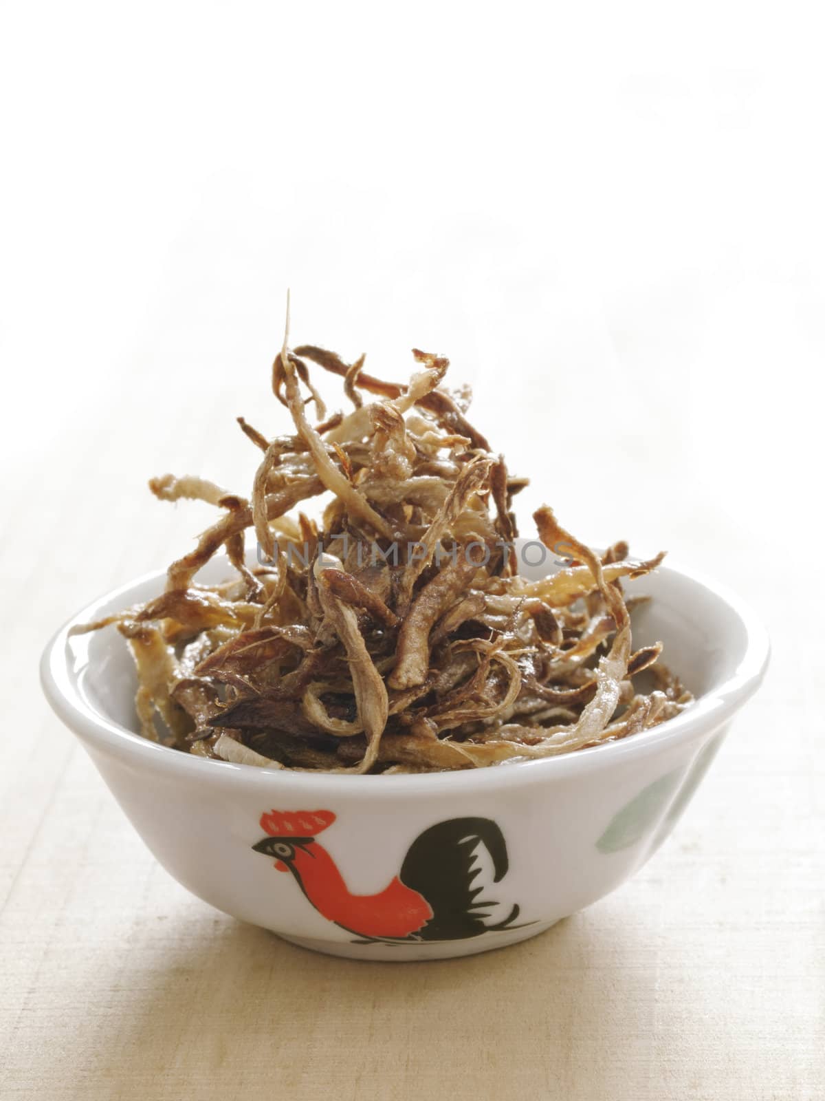 close up of a bowl of fried julienned ginger