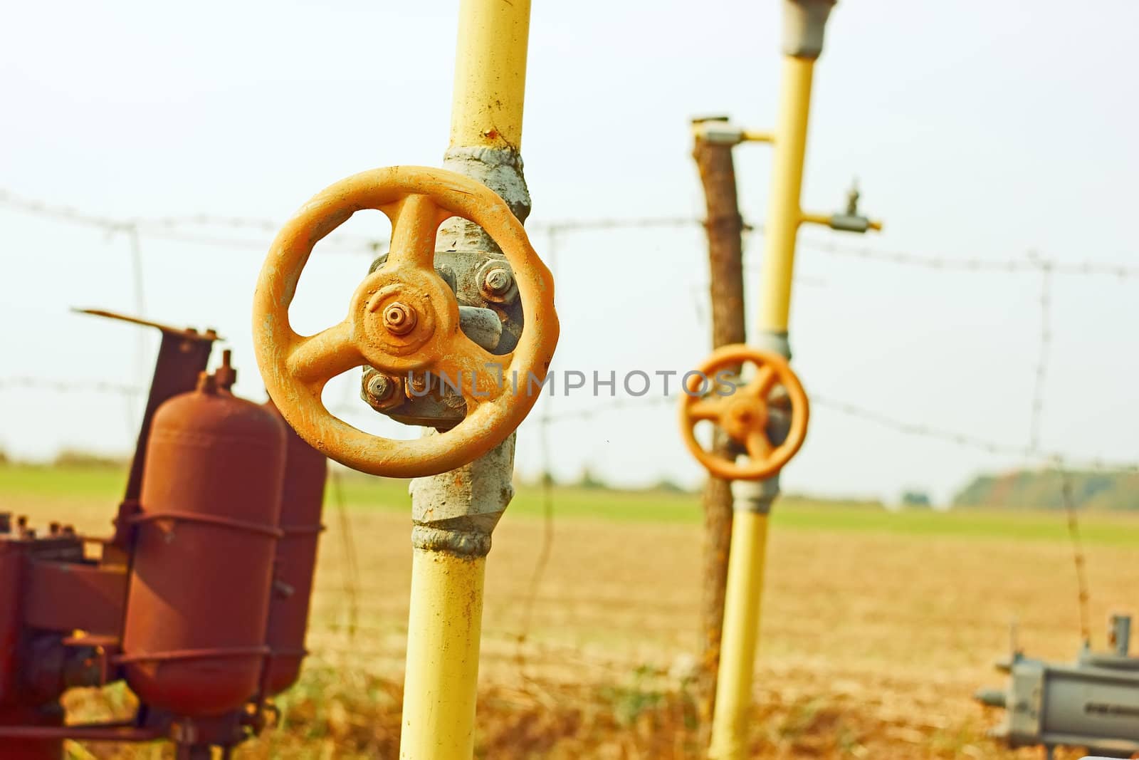 Equipment of natural gas station among autumn fields