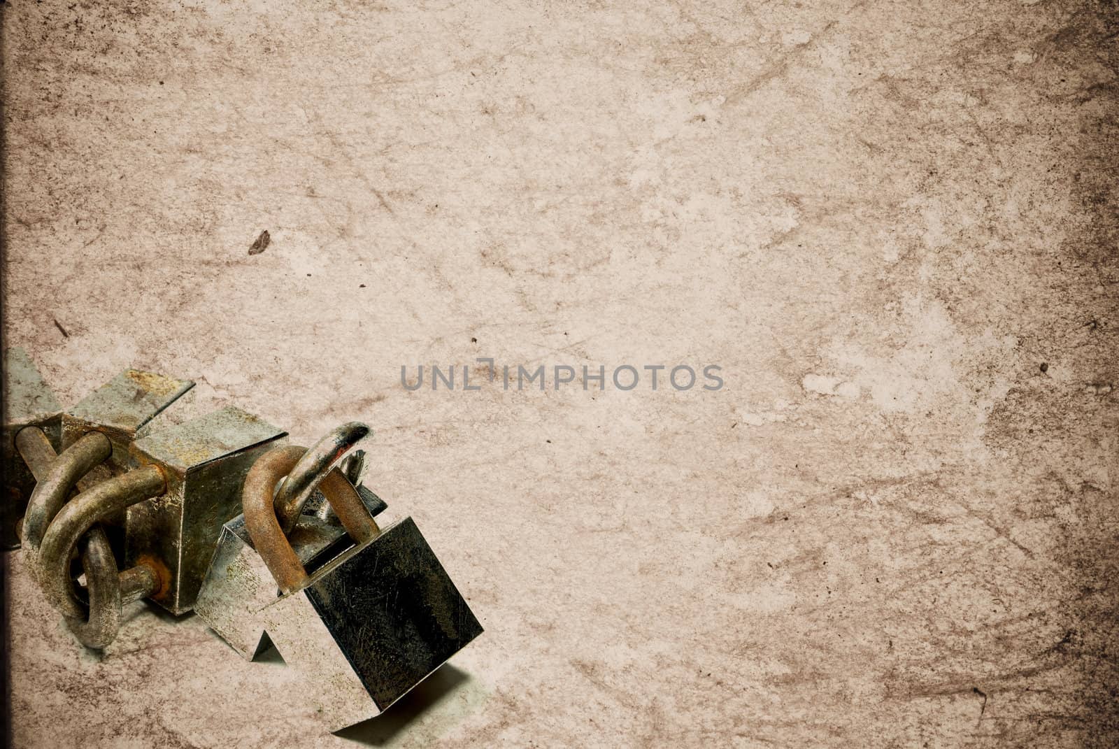 Rusty old aged padlocks on vintage paper background