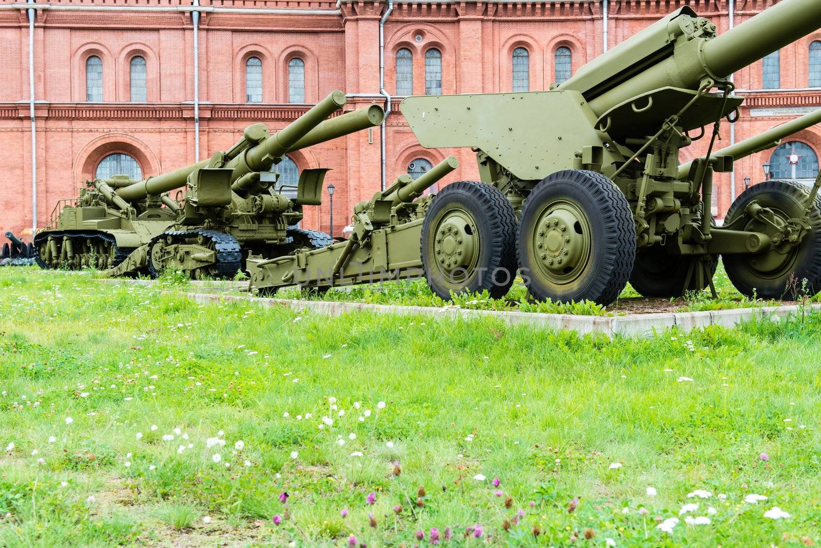 Old vintage Russian artillery systems and equipment on green grass taken on a sunny day, can be use for various military purposes