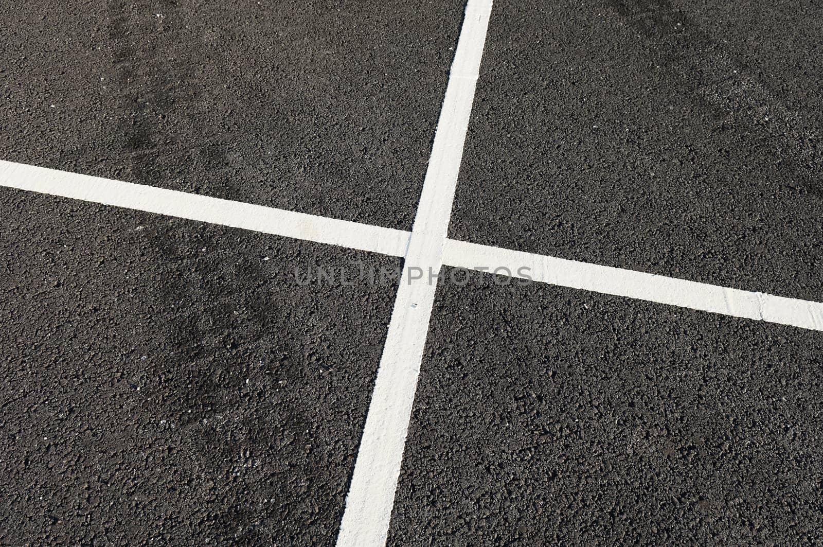 Detail of tire marks and white stripes painted on the road