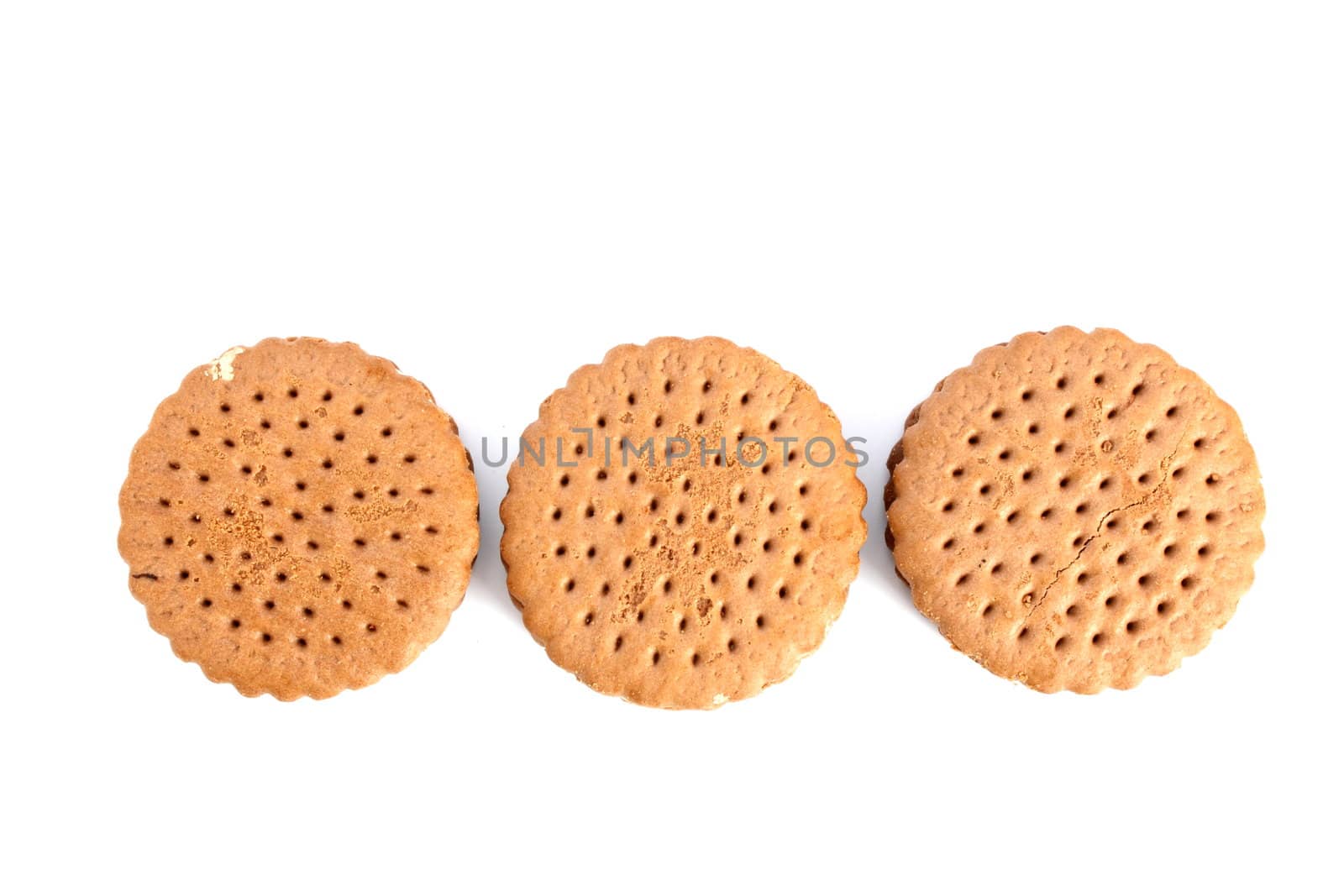 three round biscuits over white background