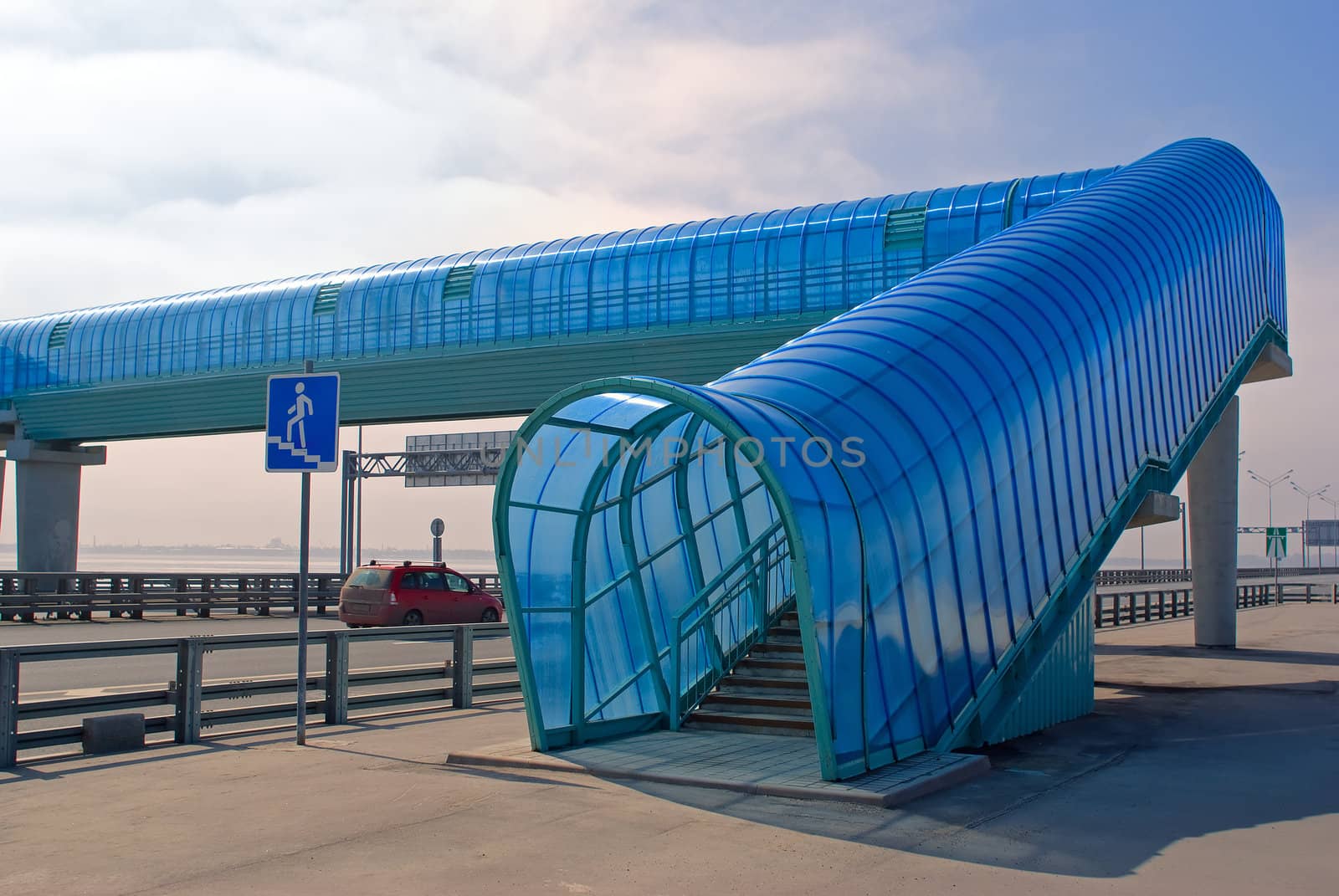 Pedestrian crossing over highway in sunny day