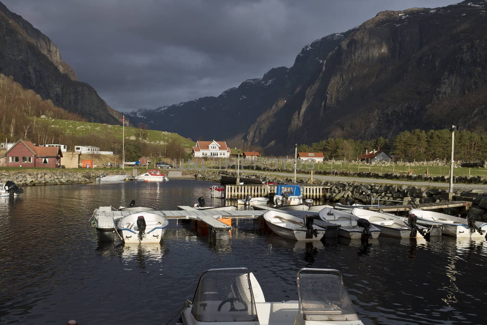 small harbor with mountains in background by gewoldi