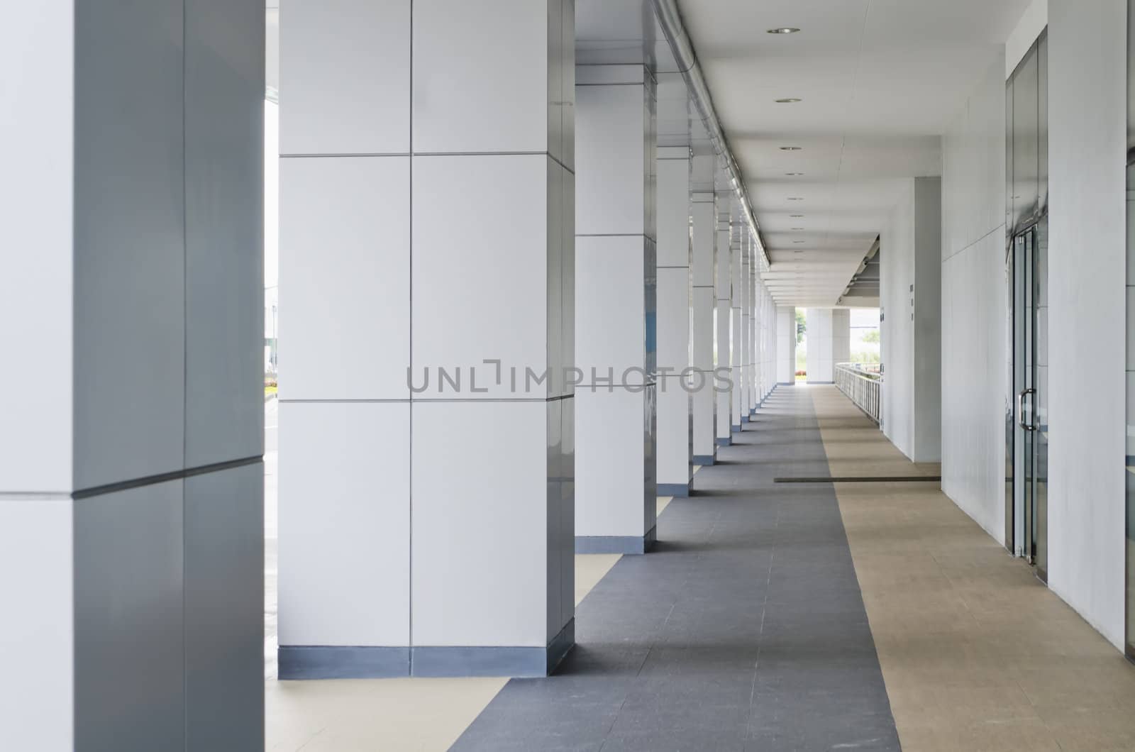 Passageway leading to a multi-level building parking lot.