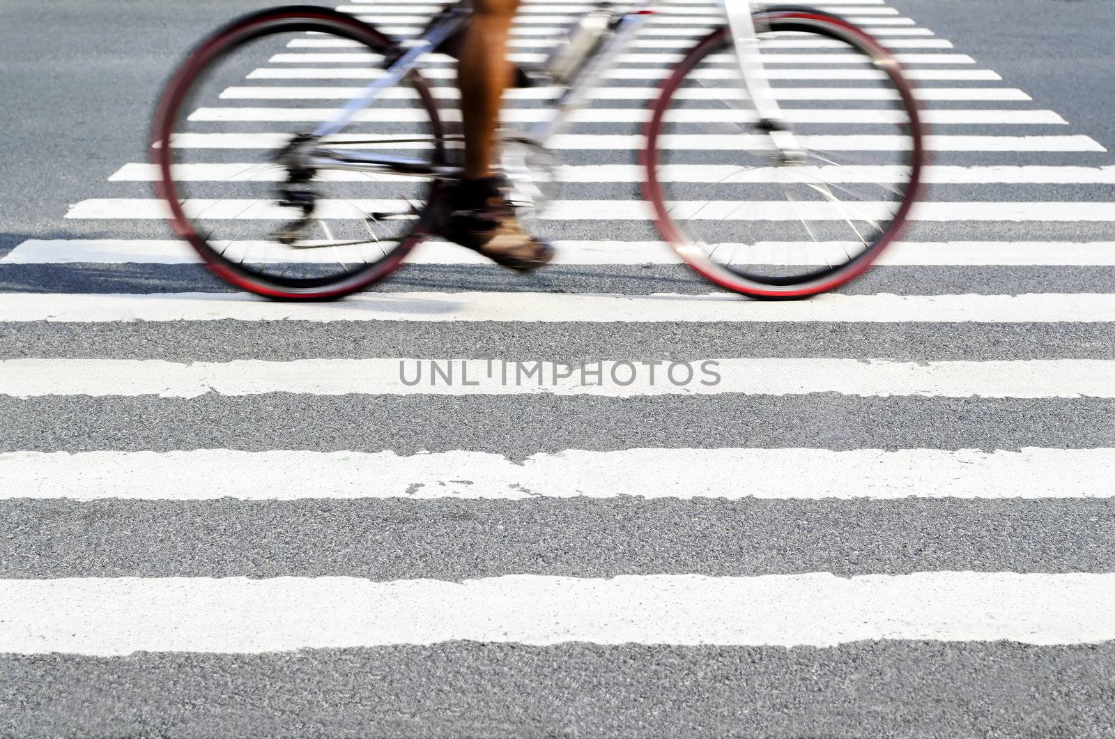 Blur of cyclist in motion on pedestrain lane