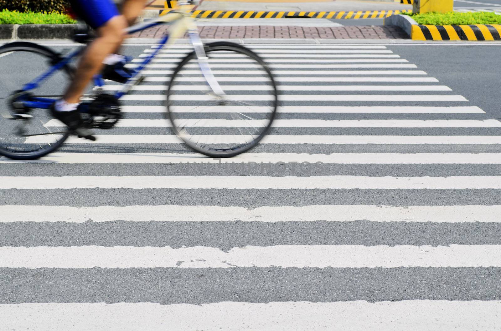 Blur of cyclist in motion on pedestrian lane