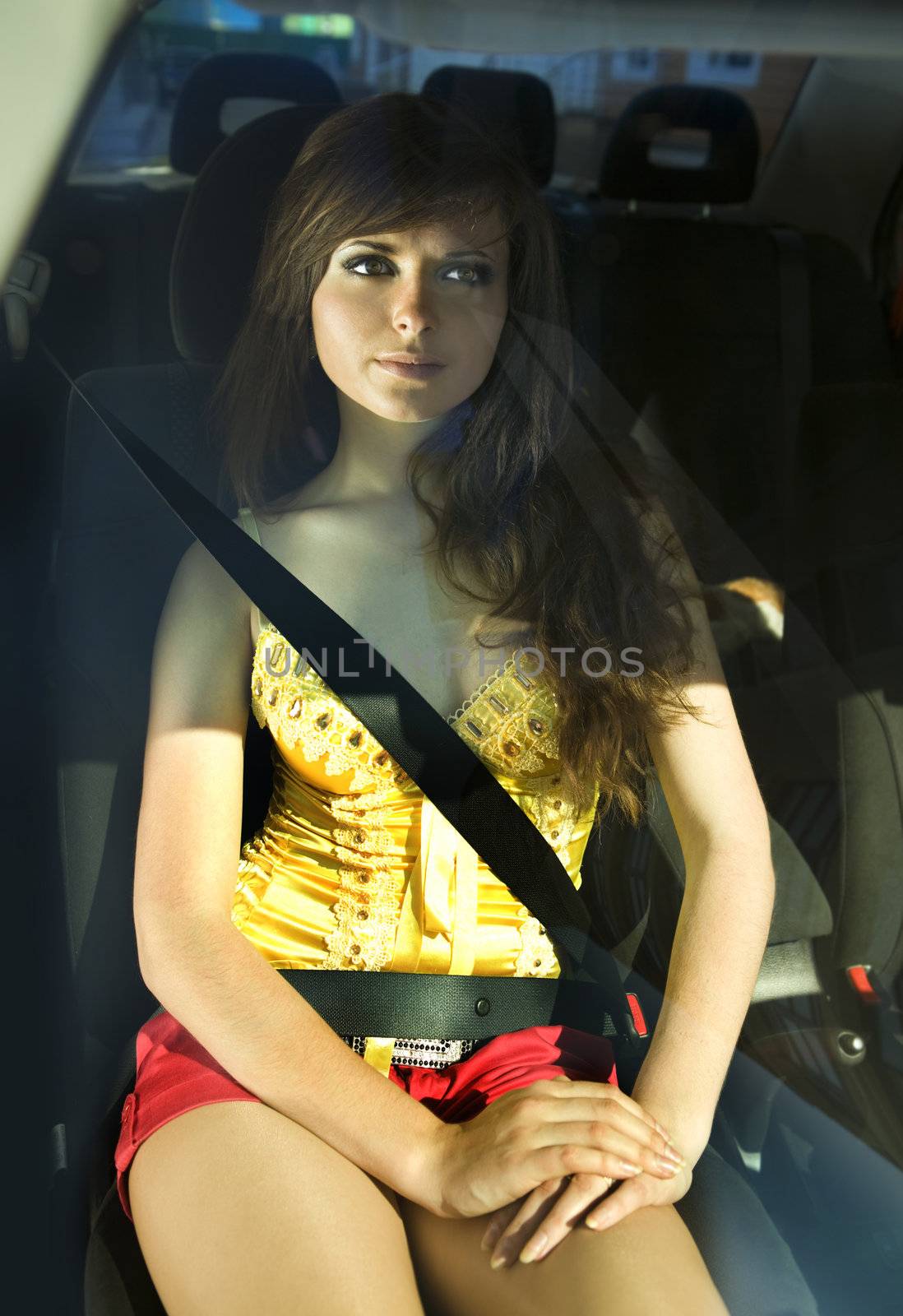 beautiful girl in car fastened by seat belt