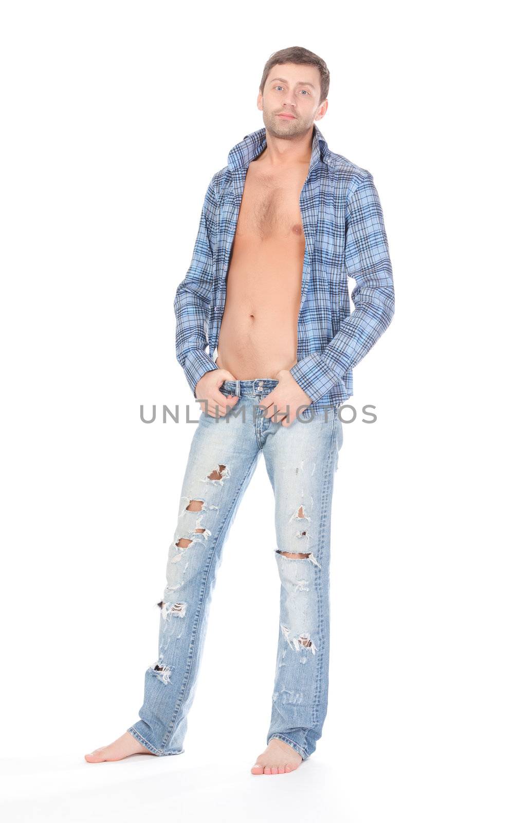 Handsome casual man standing barefoot in trendy ragged jeans  over a white background
