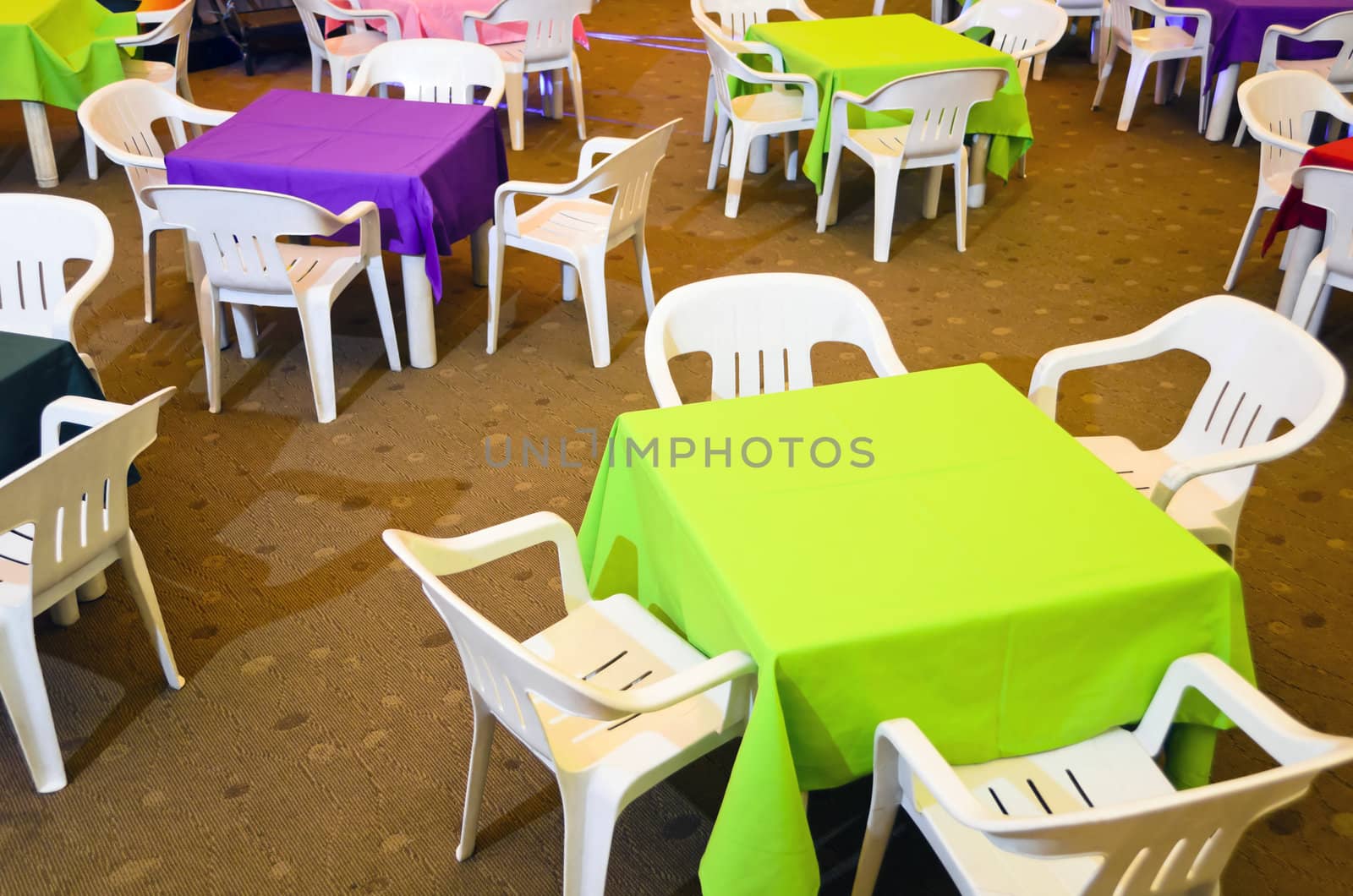 Colorful children's party tables and plastic chairs.