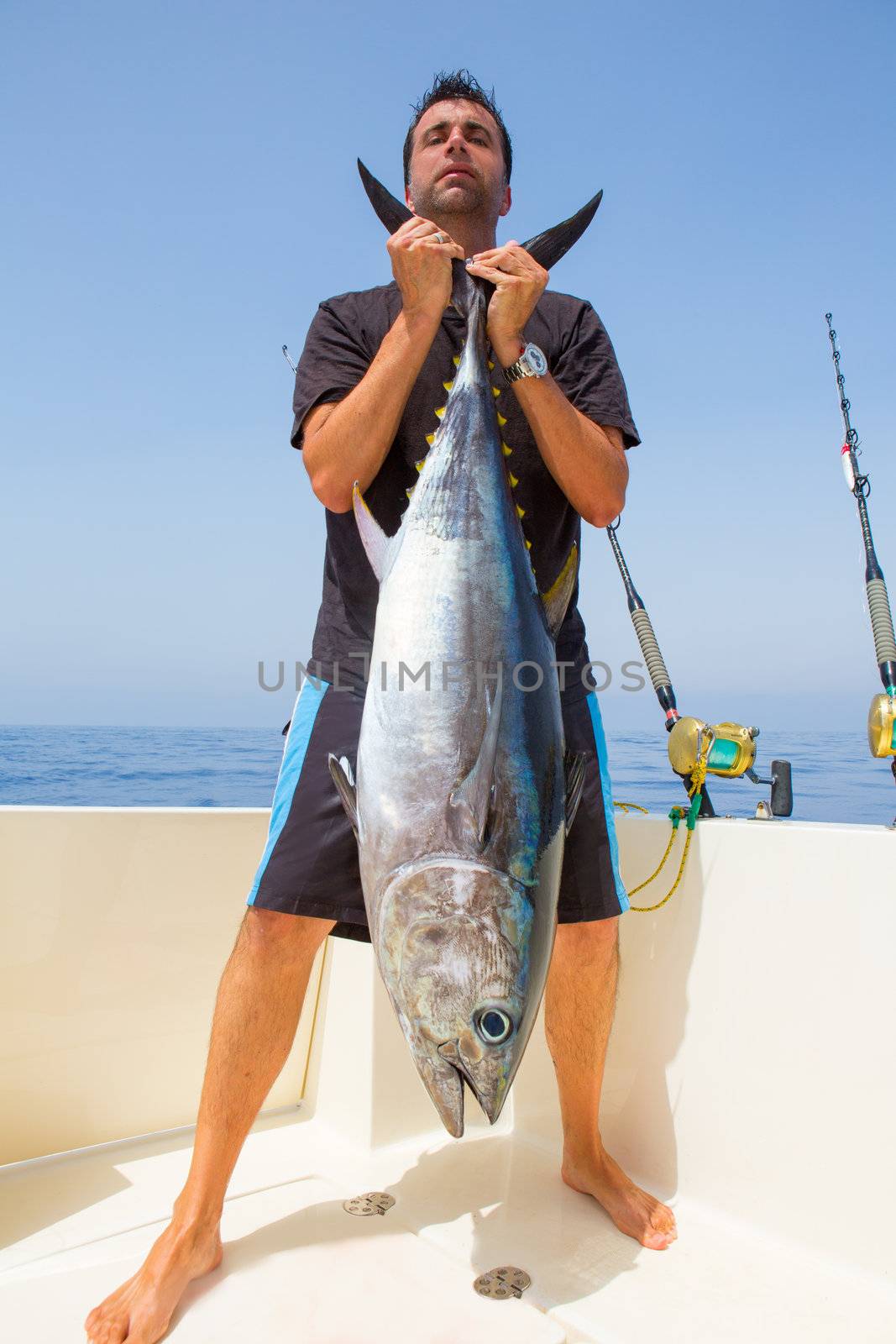 big Bluefin tuna catch by fisherman on boat trolling posing on deck