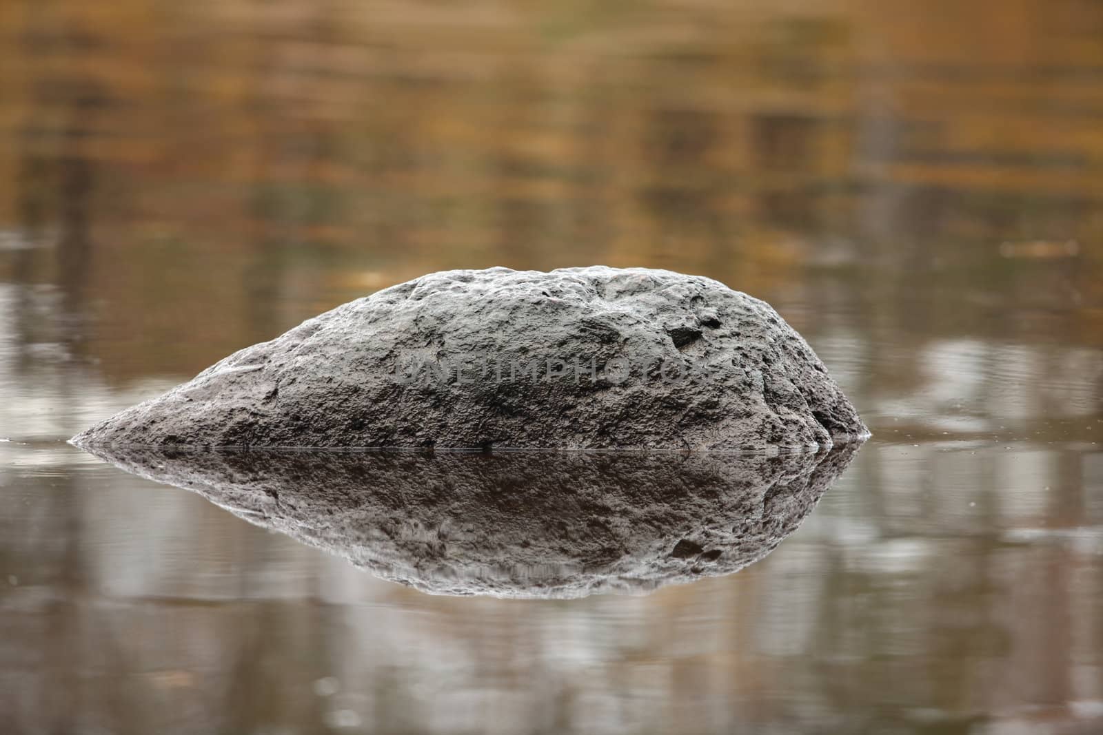 the black meteorite is reflected in water