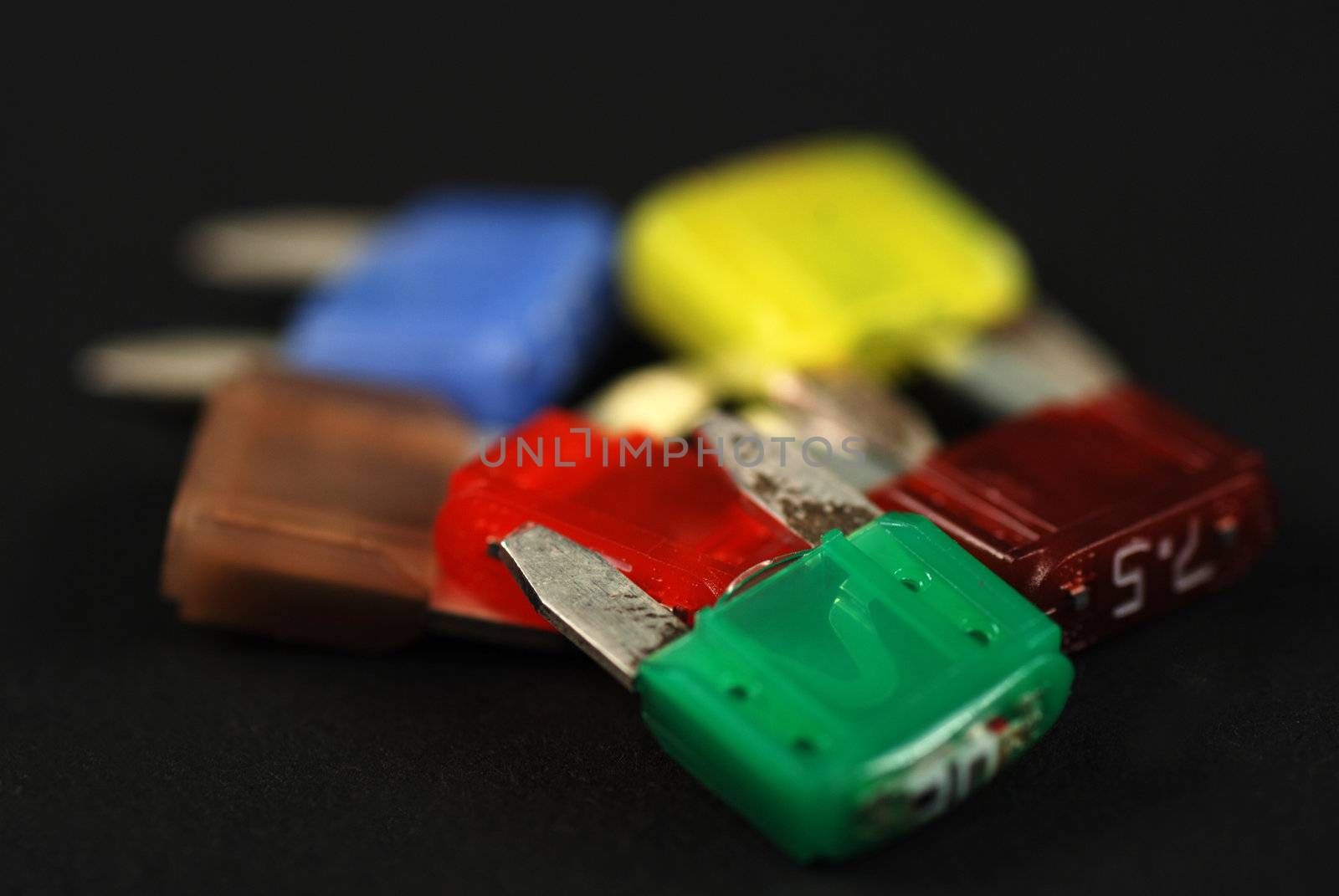 electrical automobile fuses with shallow depth of field on black background