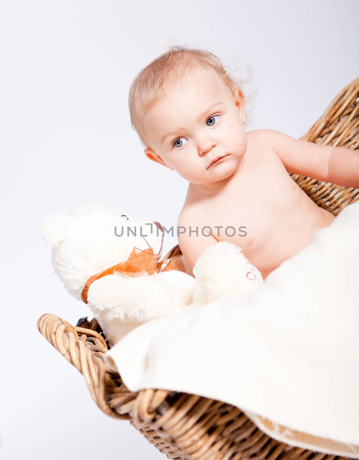 cute little baby infant in basket with white teddy bear
