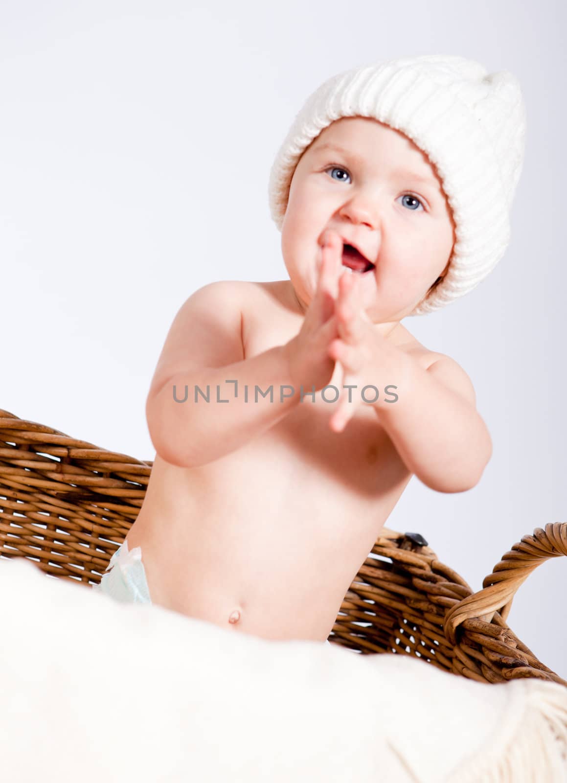 cute little baby infant in basket with white teddy bear