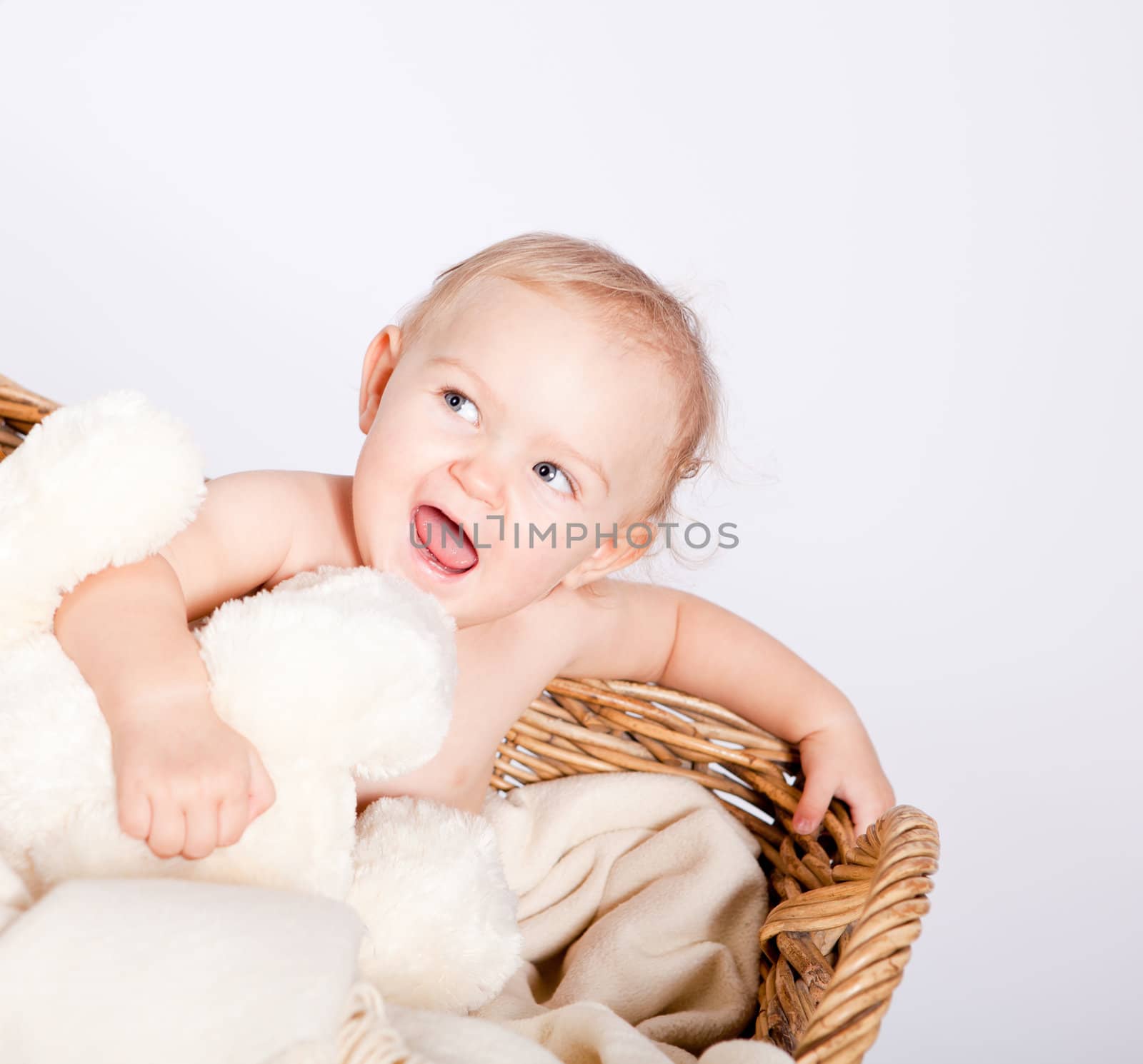 cute little baby infant in basket with white teddy bear