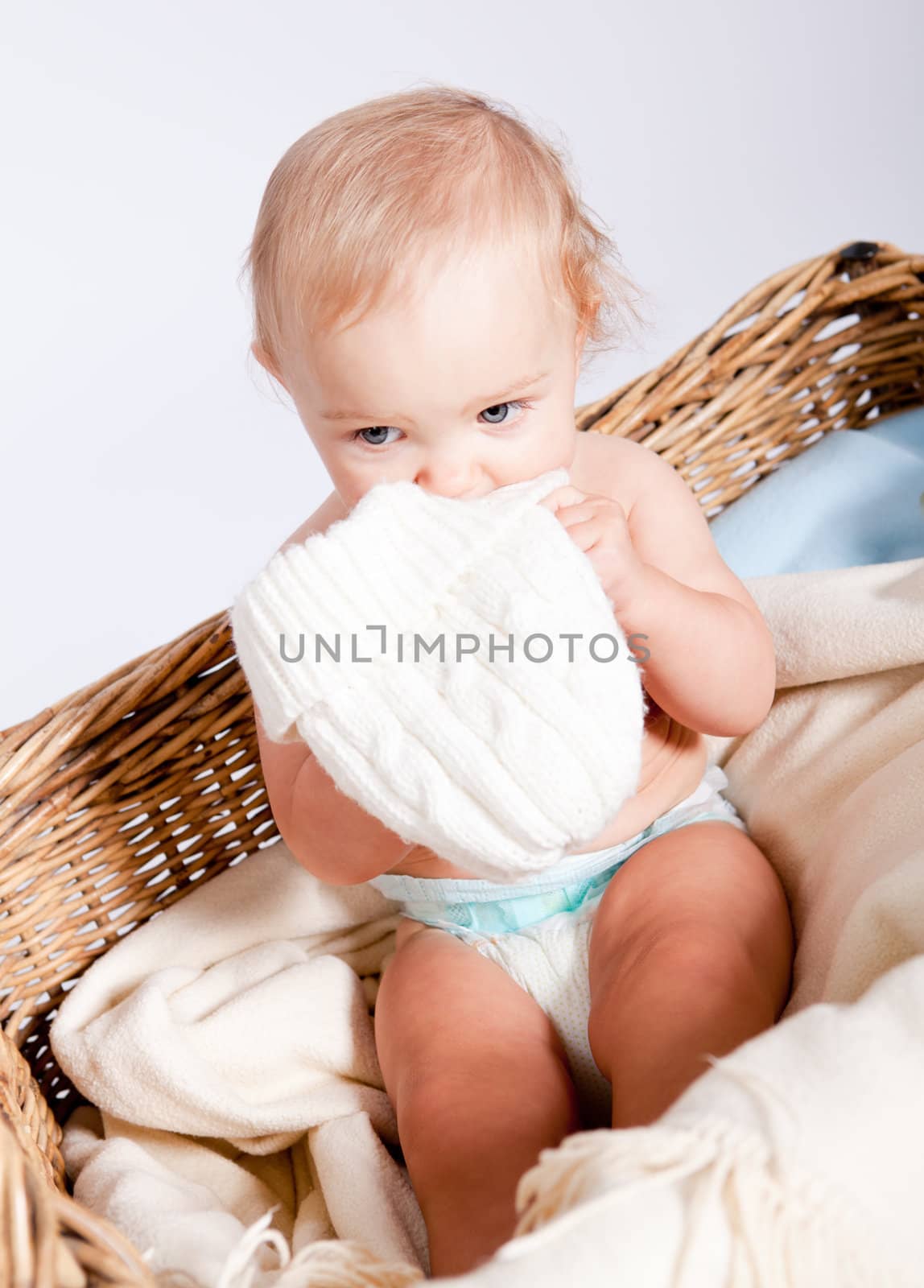 cute little baby infant in basket with white teddy bear