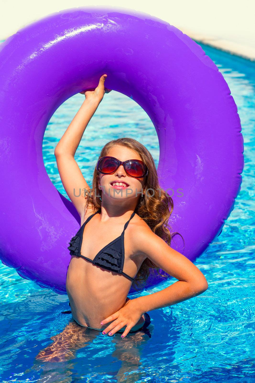 bikini kid girl with fashion sunglasses with purple inflatable pool ring