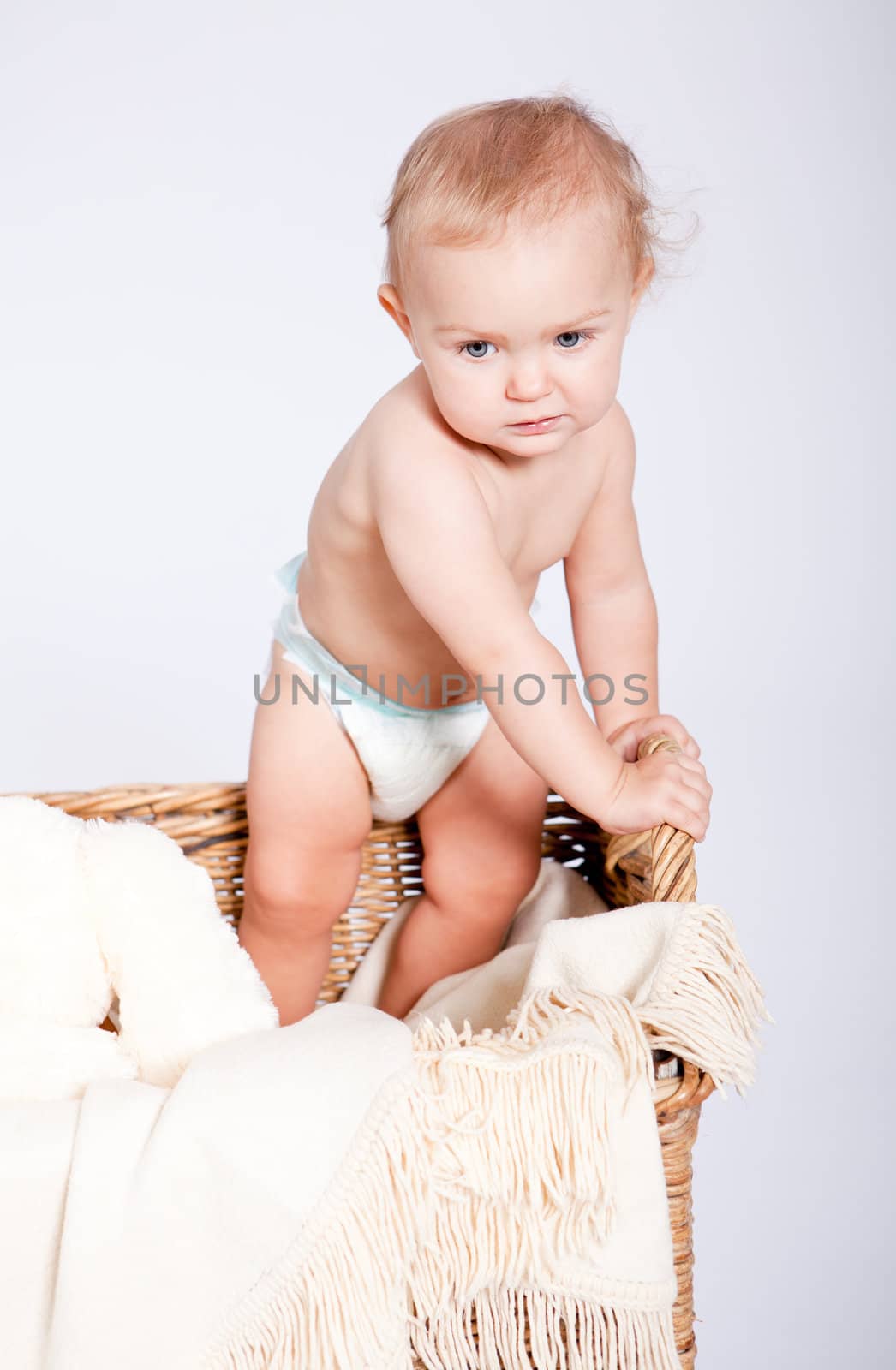 cute little baby infant in basket with white teddy bear