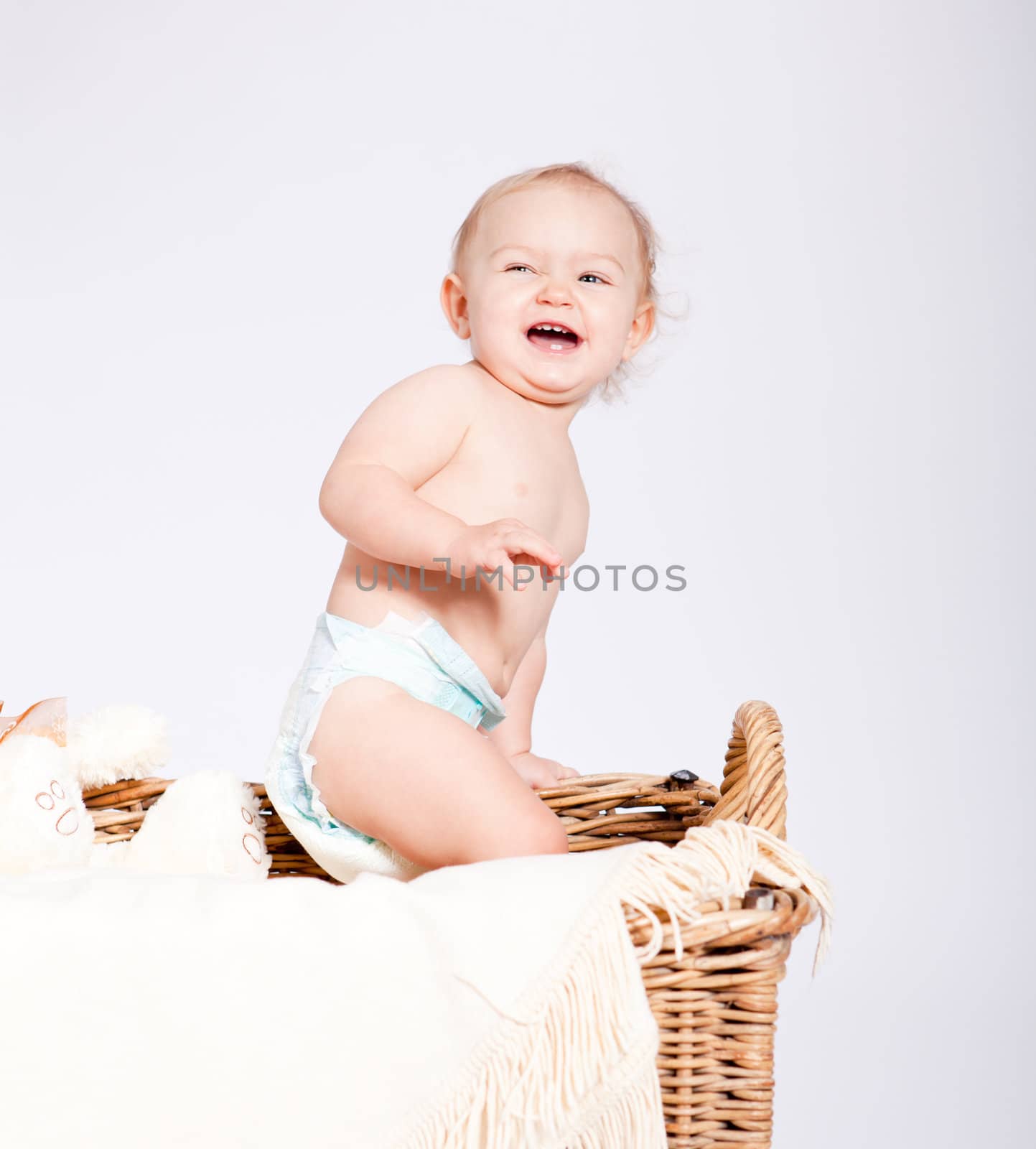 cute little baby infant in basket with white teddy bear
